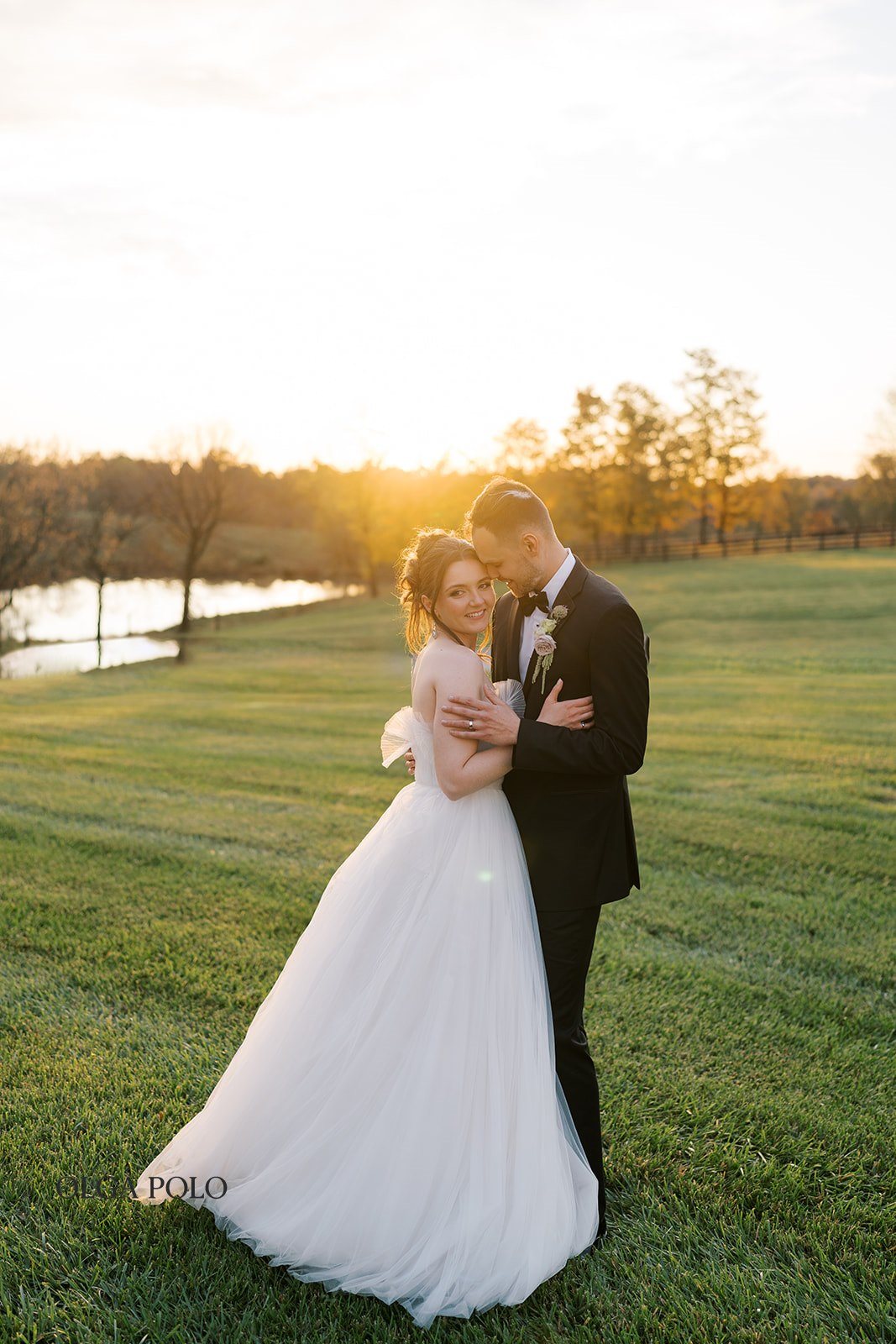Maia and Troy embracing during sunset portraits at Boone Valley Farm