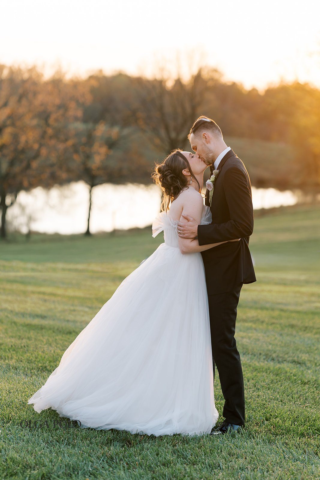 Maia and Troy kissing during sunset portraits at Boone Valley Farm