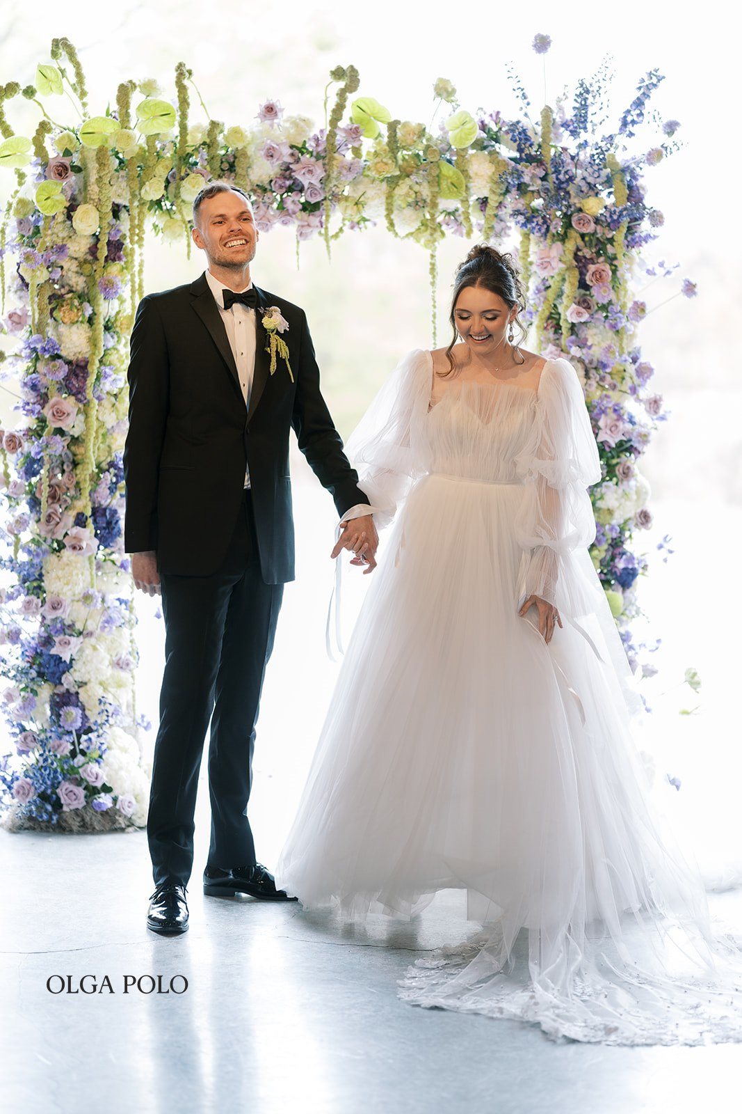 Maia and Troy walking back up the aisle after their ceremony