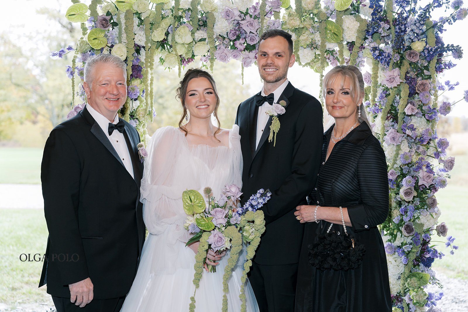 Maia and Troy posing with parents during family portraits