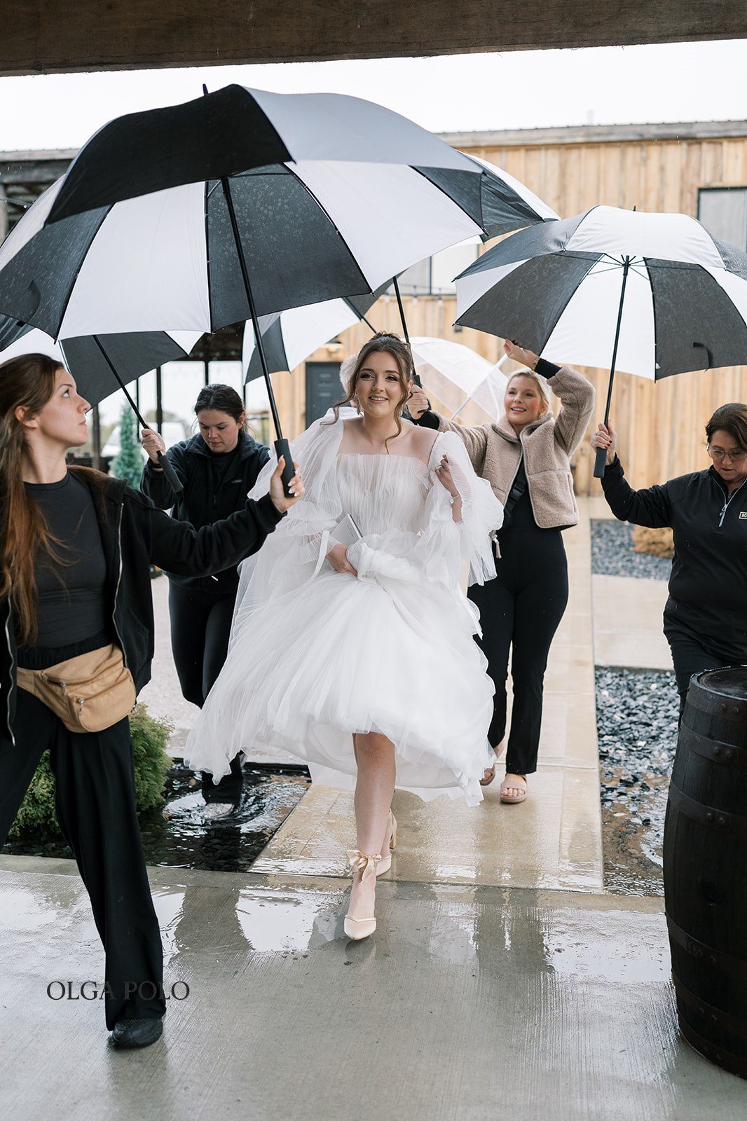 Maia approaching the first look beneath a clear umbrella