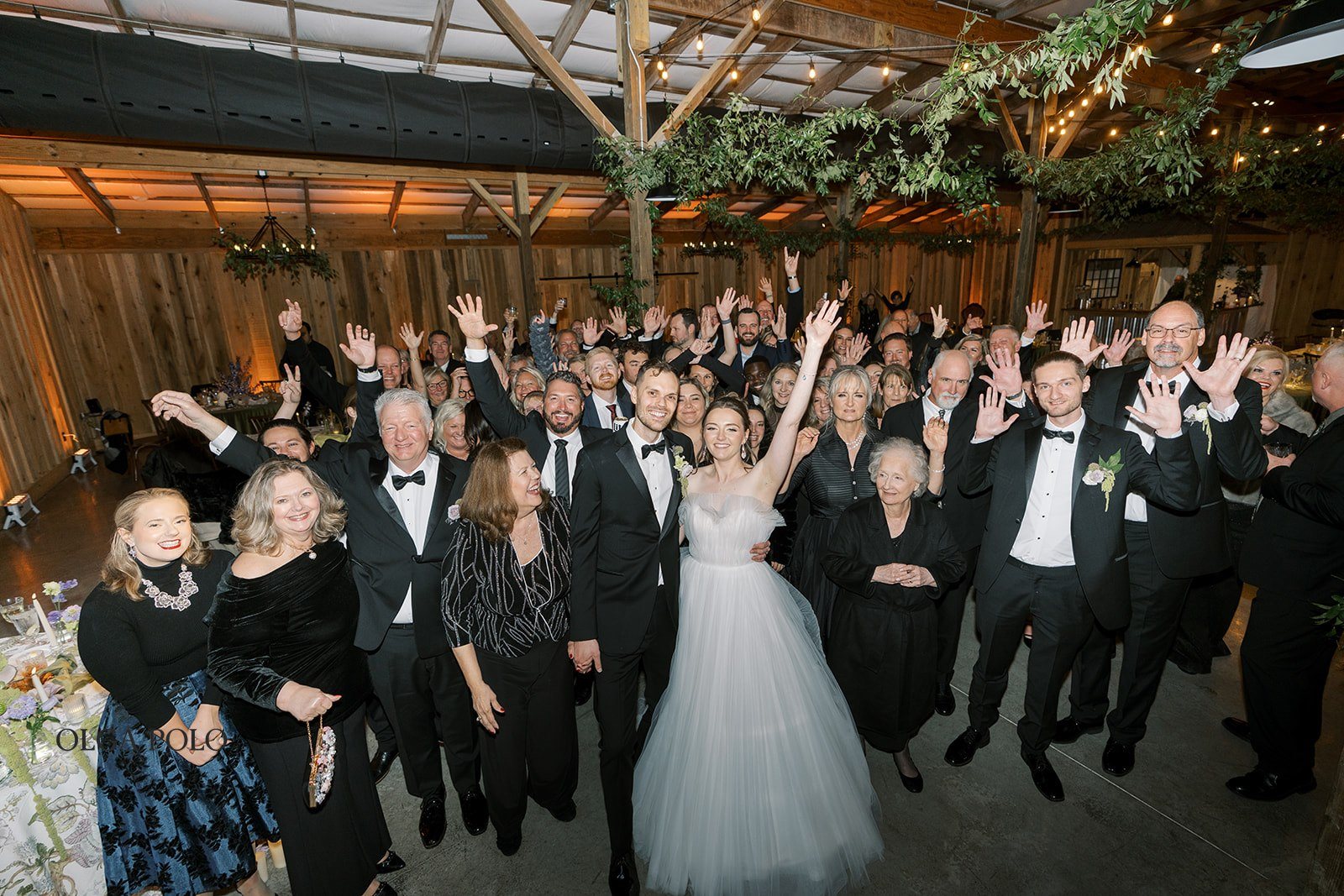 Large group of guests celebrating together during the reception