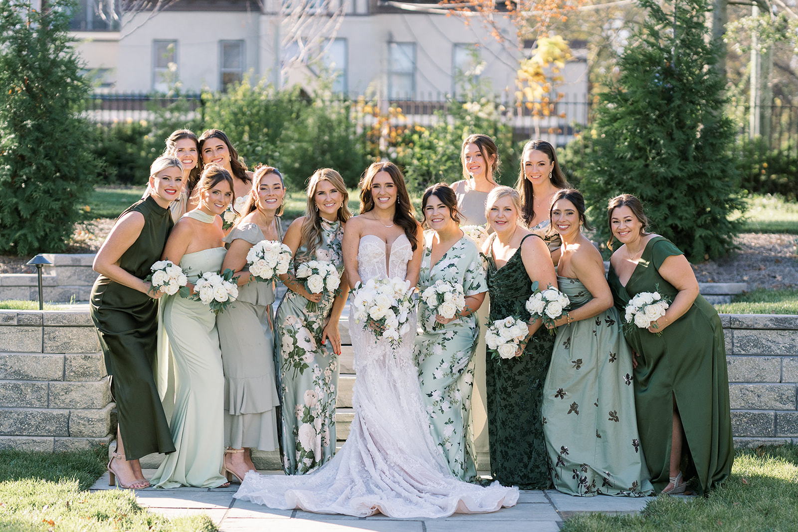 Ronnie with her bridesmaids in green dresses during an outdoor wedding-day portrait