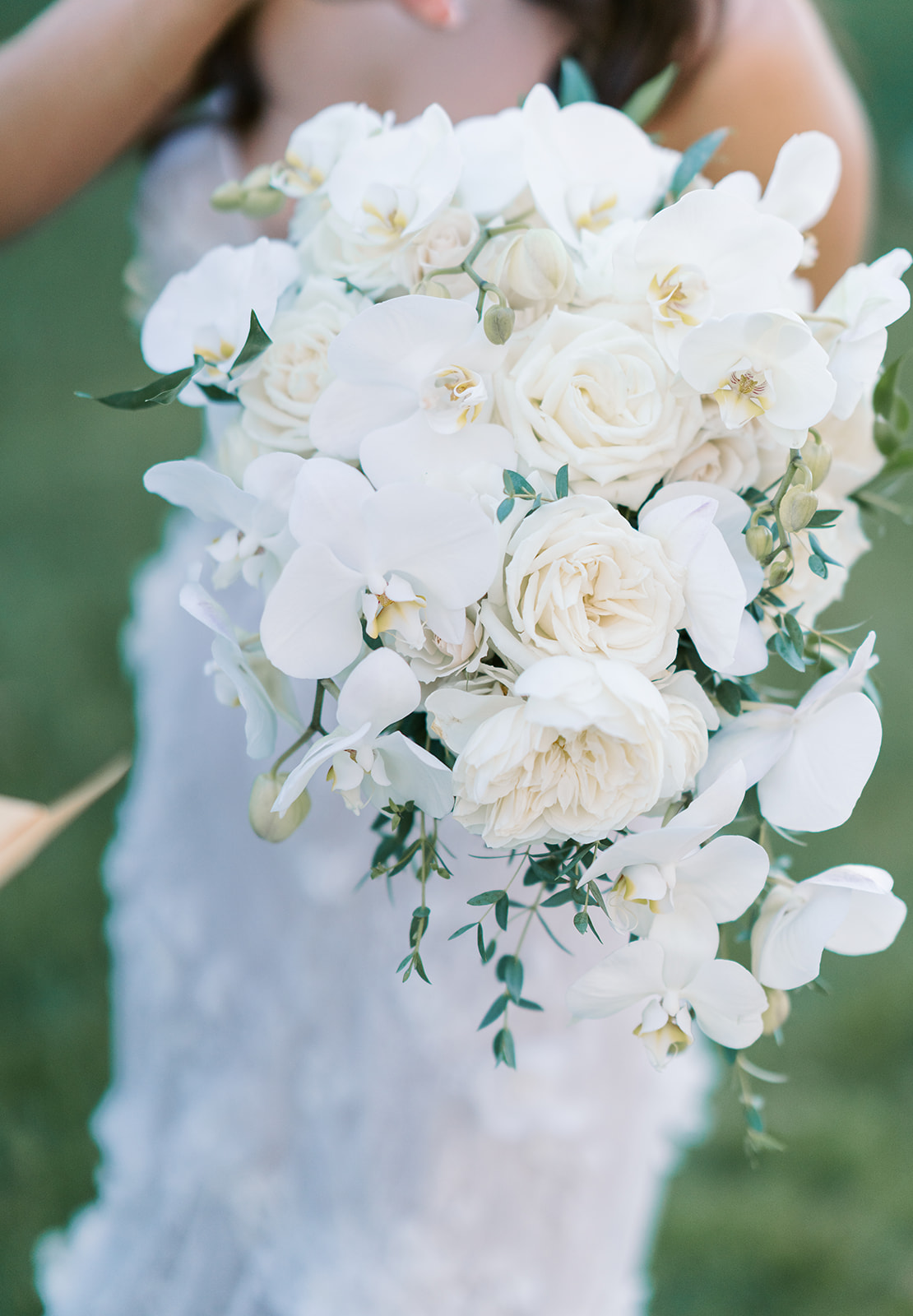 Close-up of Ronnie's white bridal bouquet with soft greenery