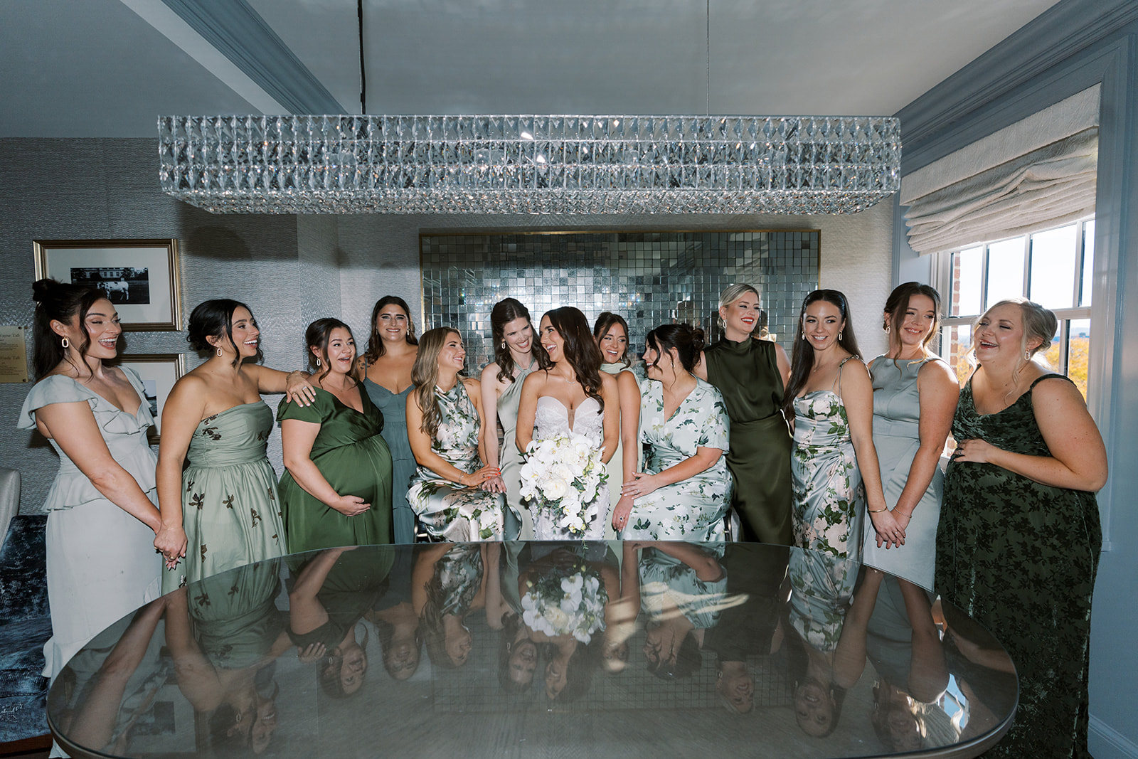 Ronnie and her bridesmaids gathered around a mirror during wedding-day preparations