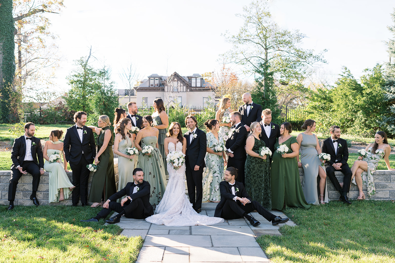 Ronnie and Patrick with their wedding party in a playful outdoor group portrait