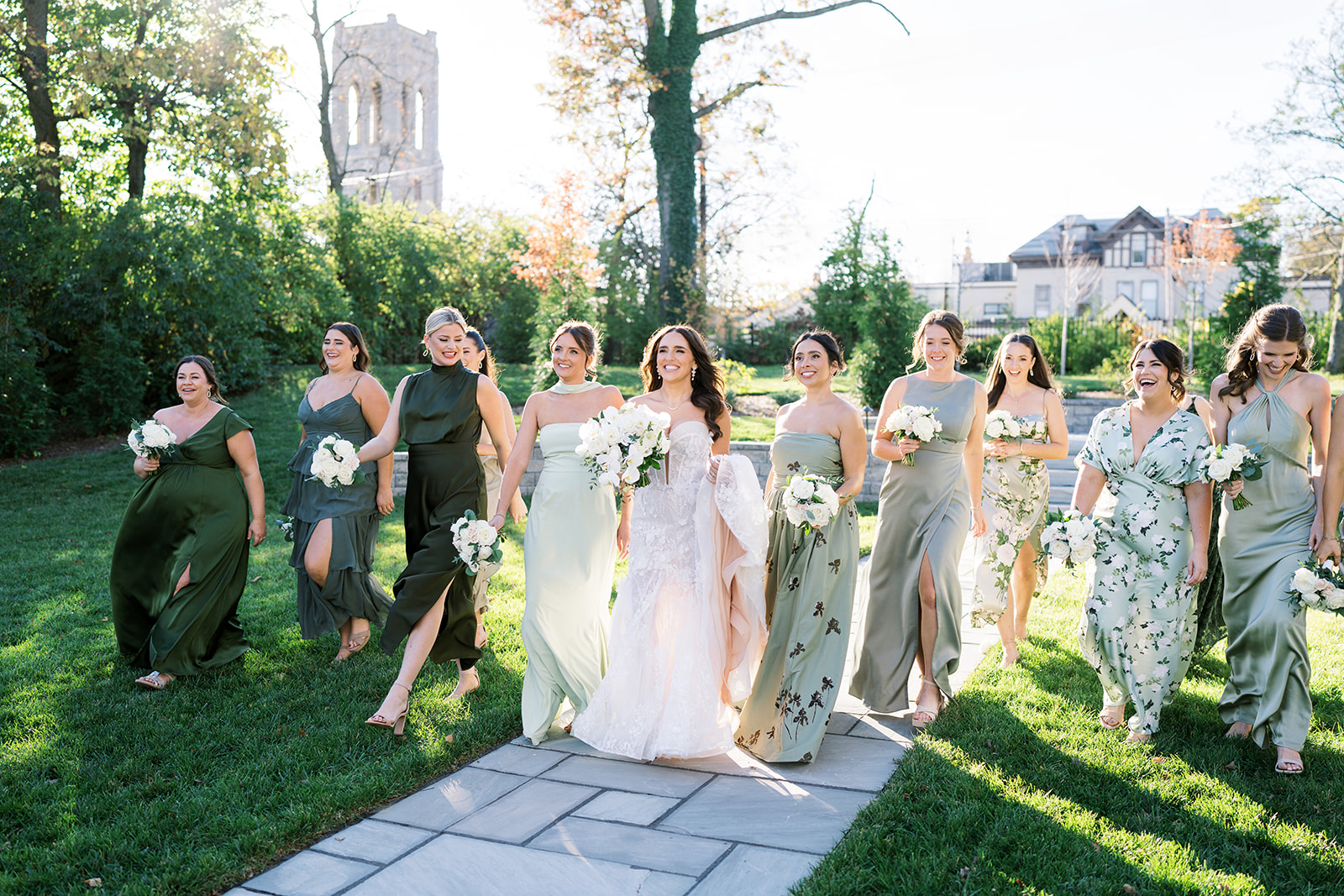 Ronnie and Patrick walking outside with their wedding party in formal black-tie attire