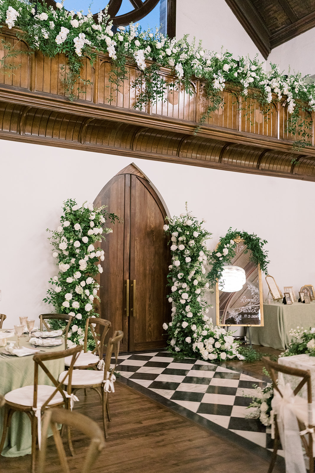 White floral ceremony installation and checkerboard aisle inside The Palomar Cincinnati