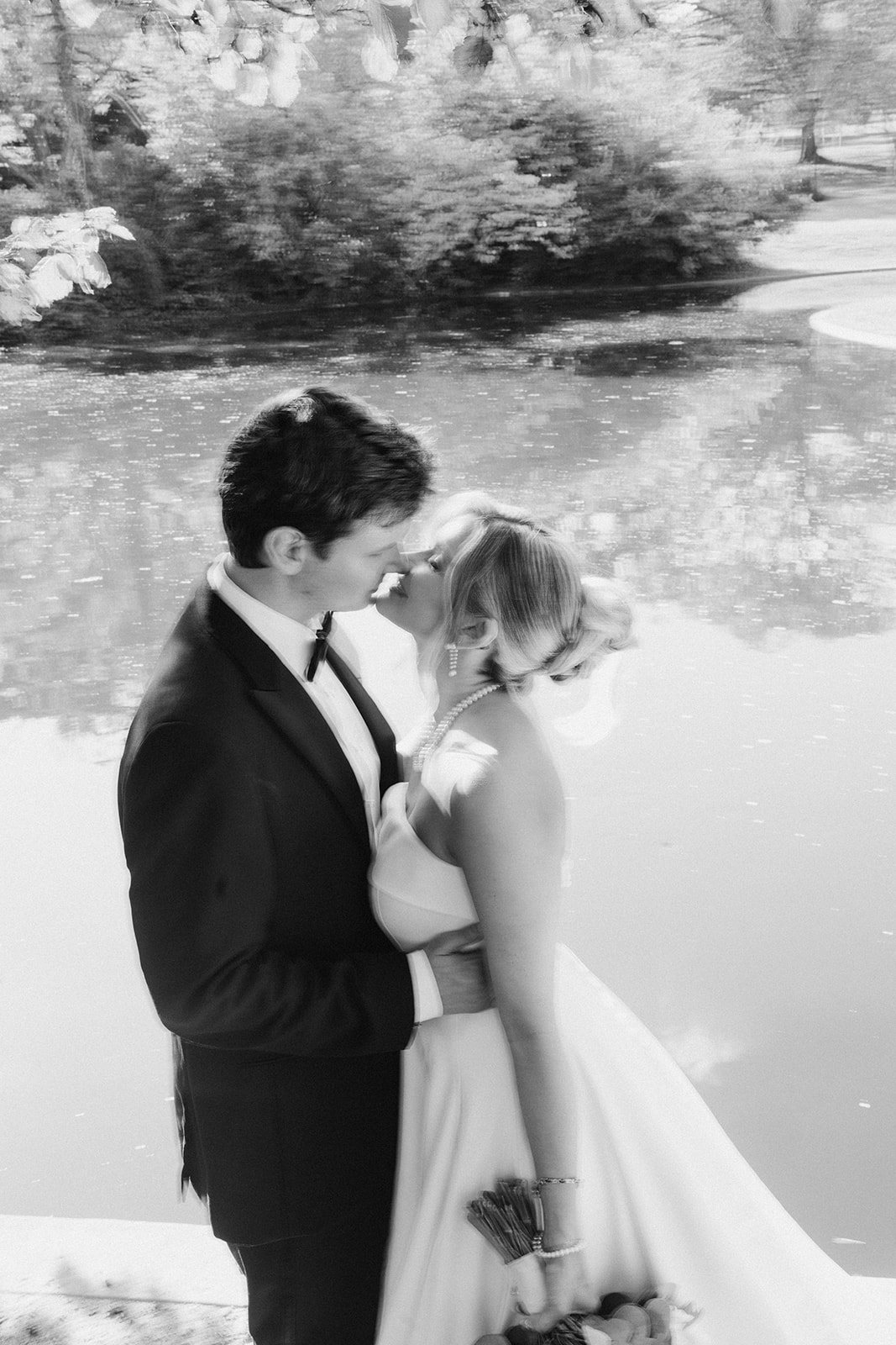 Black-and-white portrait of Andee and Quinn embracing outdoors