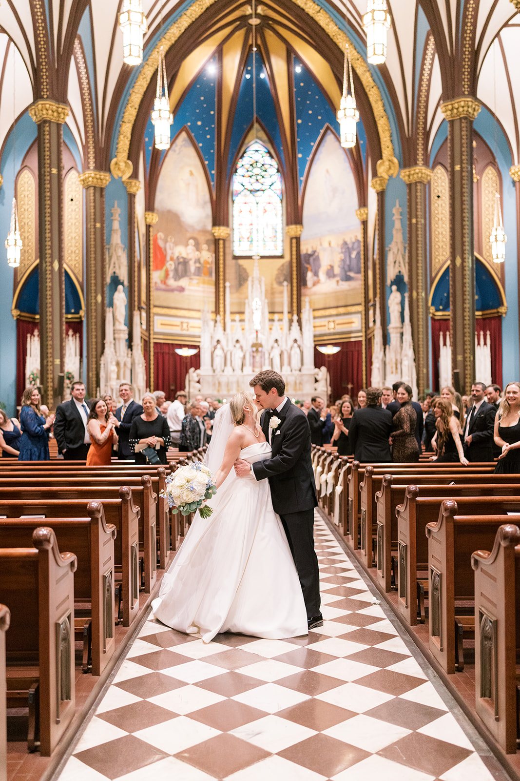 Andee and Quinn walking the aisle inside St. Francis Xavier Church in Cincinnati