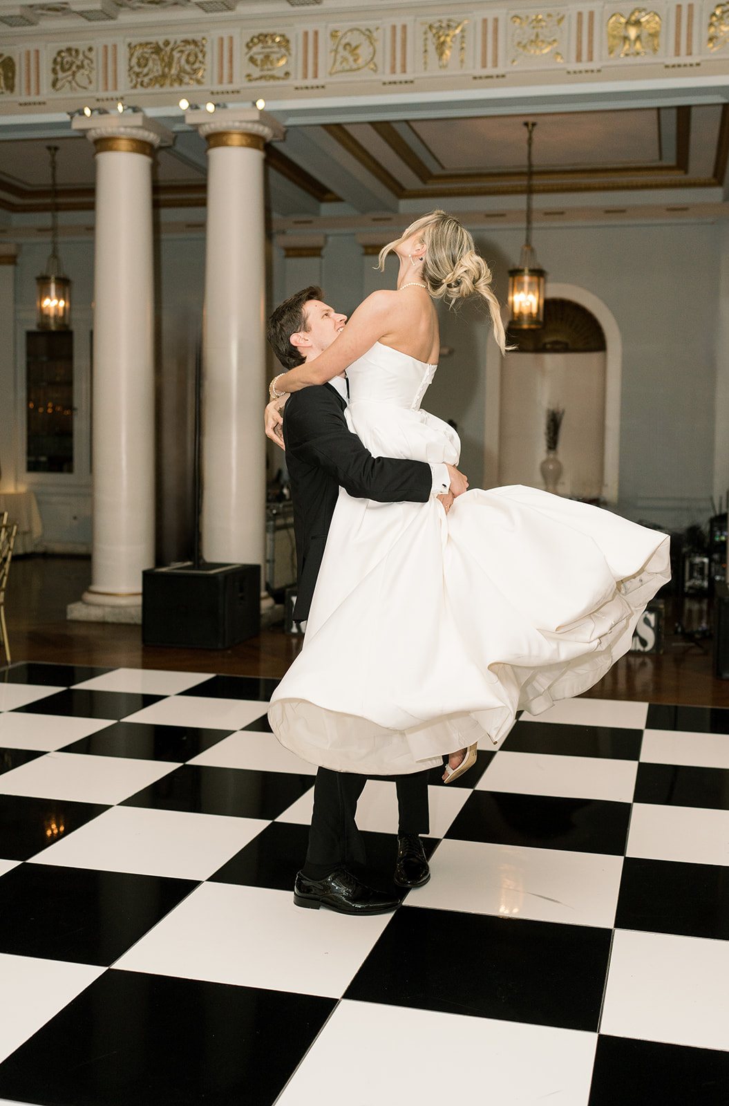 Quinn lifting Andee on the black-and-white dance floor at The Cincinnati Club