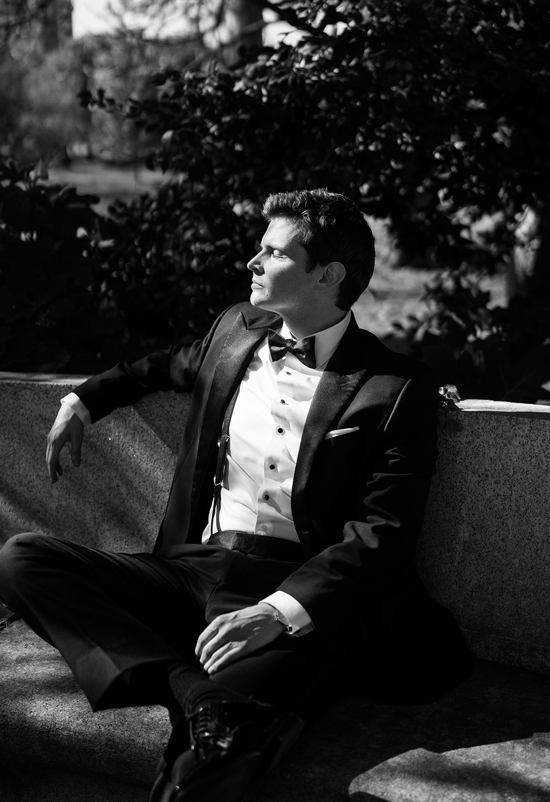 Quinn in a black tuxedo during a wedding-day portrait outdoors