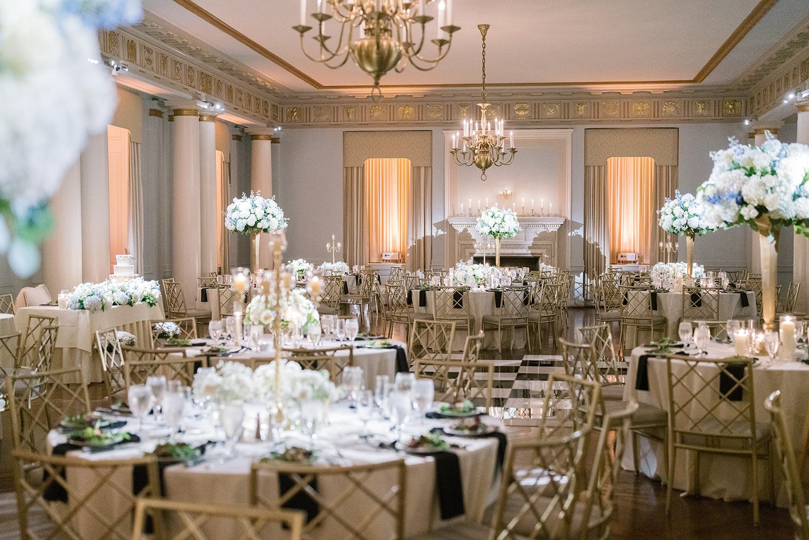 Round reception tables with white florals and warm lighting at The Cincinnati Club