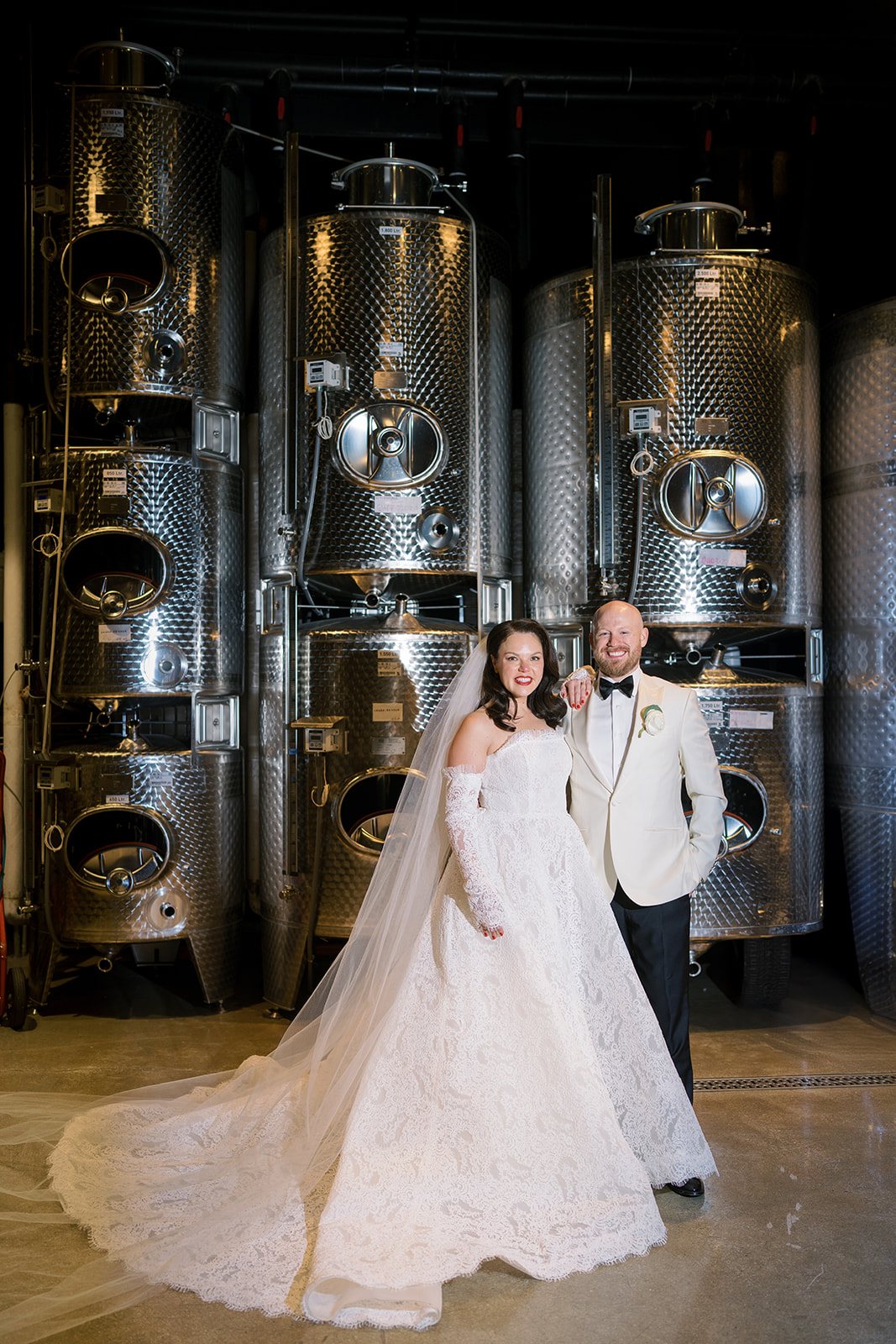 Clint and Ania posing together beside the winery tanks at Chicago Winery