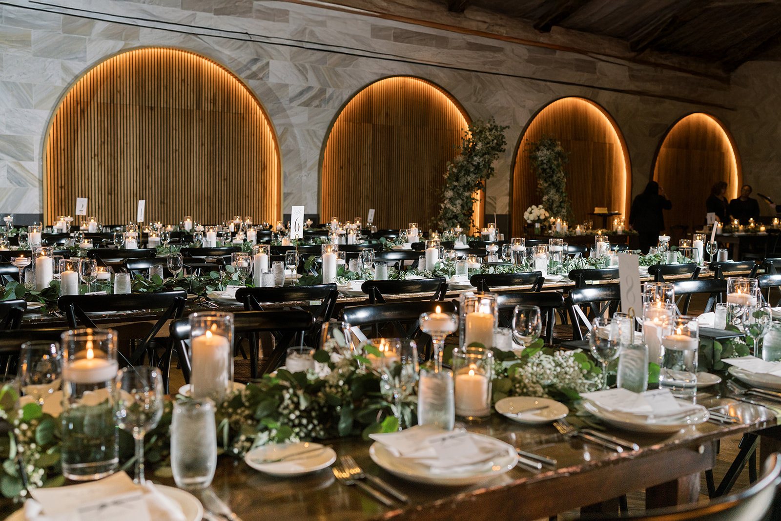 Wide view of the candlelit reception room at Chicago Winery