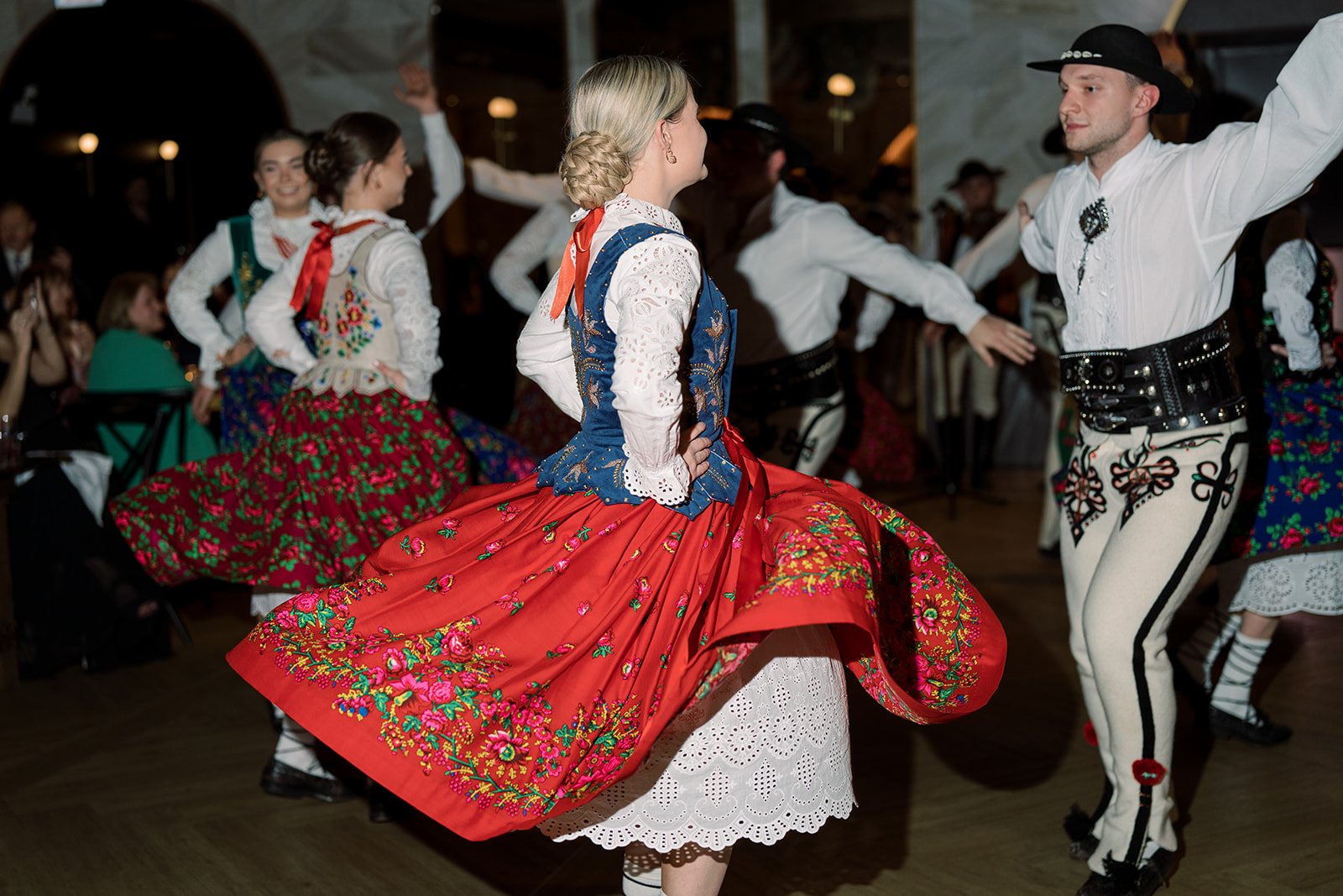 Polish folk dancer twirling in traditional dress during Ania and Clint's reception