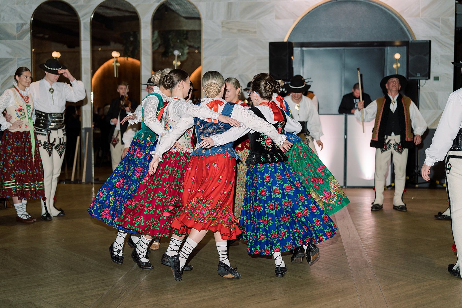 Group of Polish folk dancers performing during the wedding reception