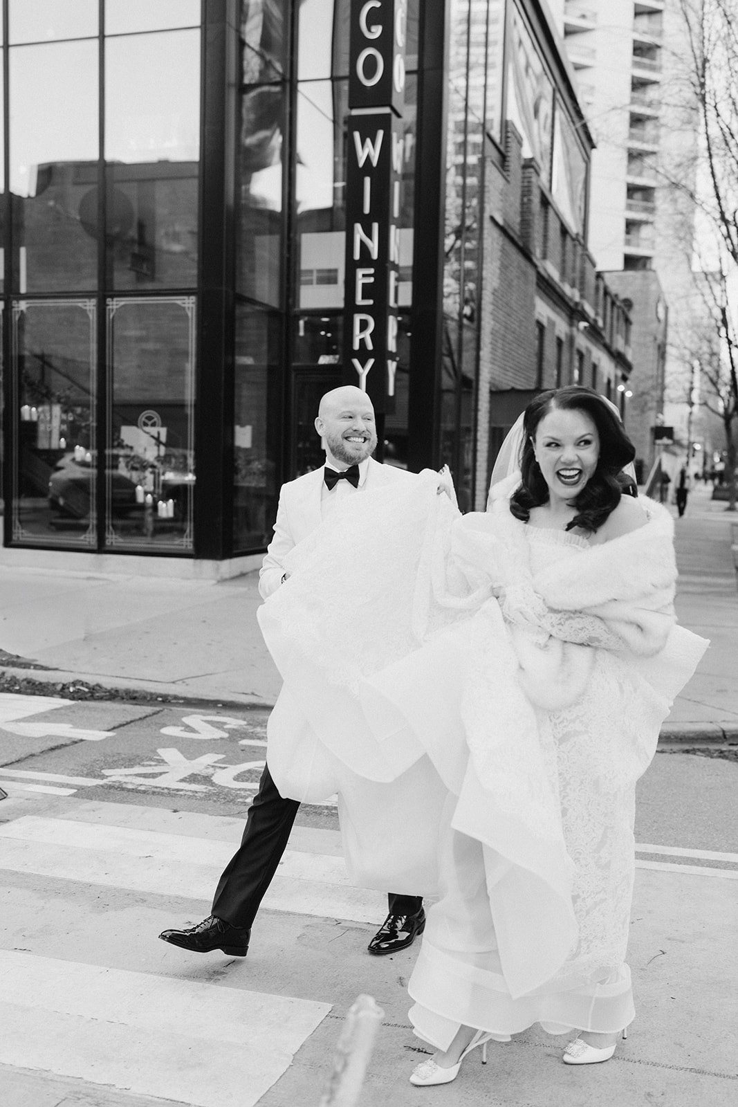 Black-and-white portrait of Clint and Ania walking outside Chicago Winery