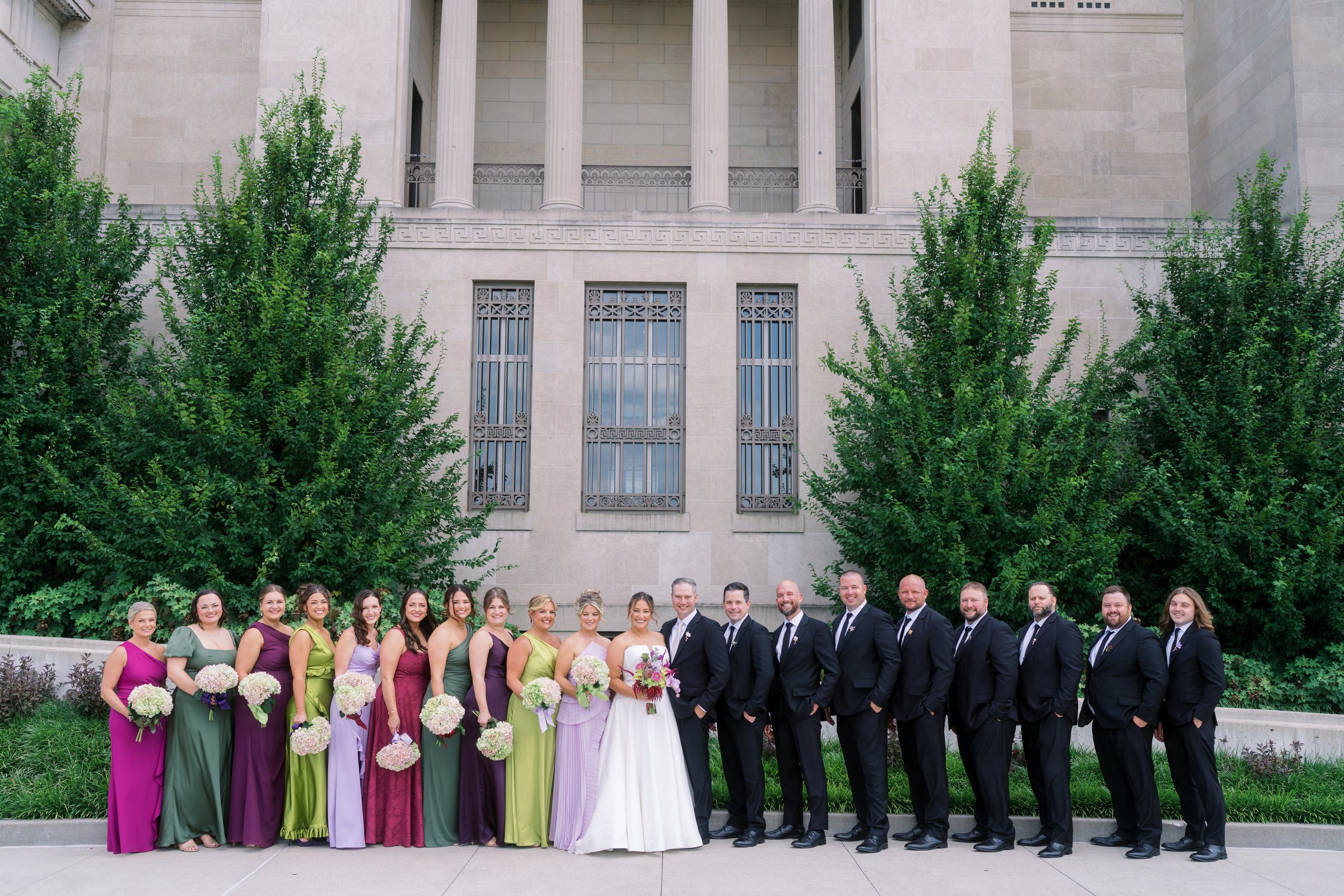 Kent and Nicolette with their wedding party in colorful formalwear