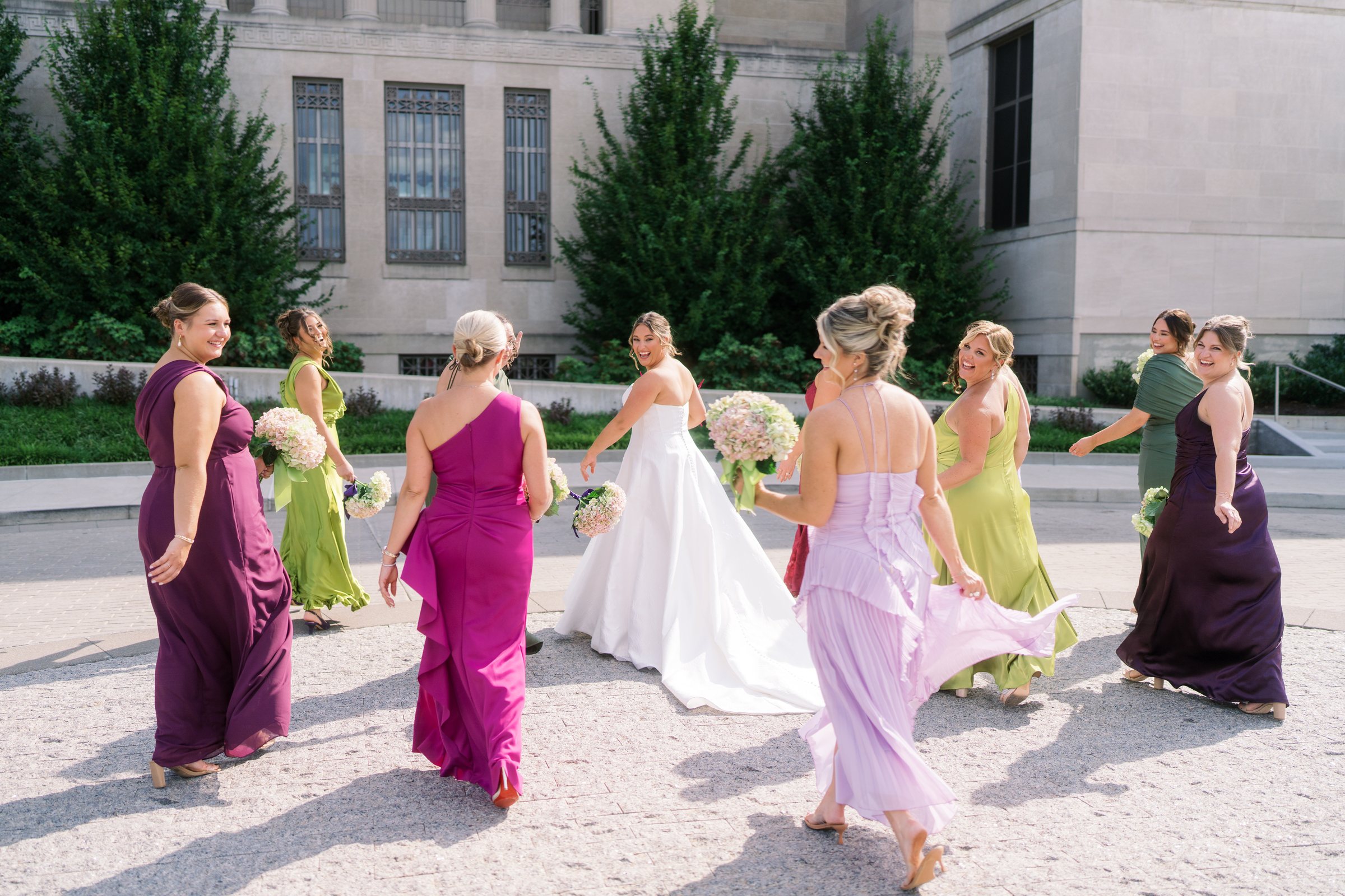 Kent and Nicolette wedding: bridesmaids walking outdoors.
