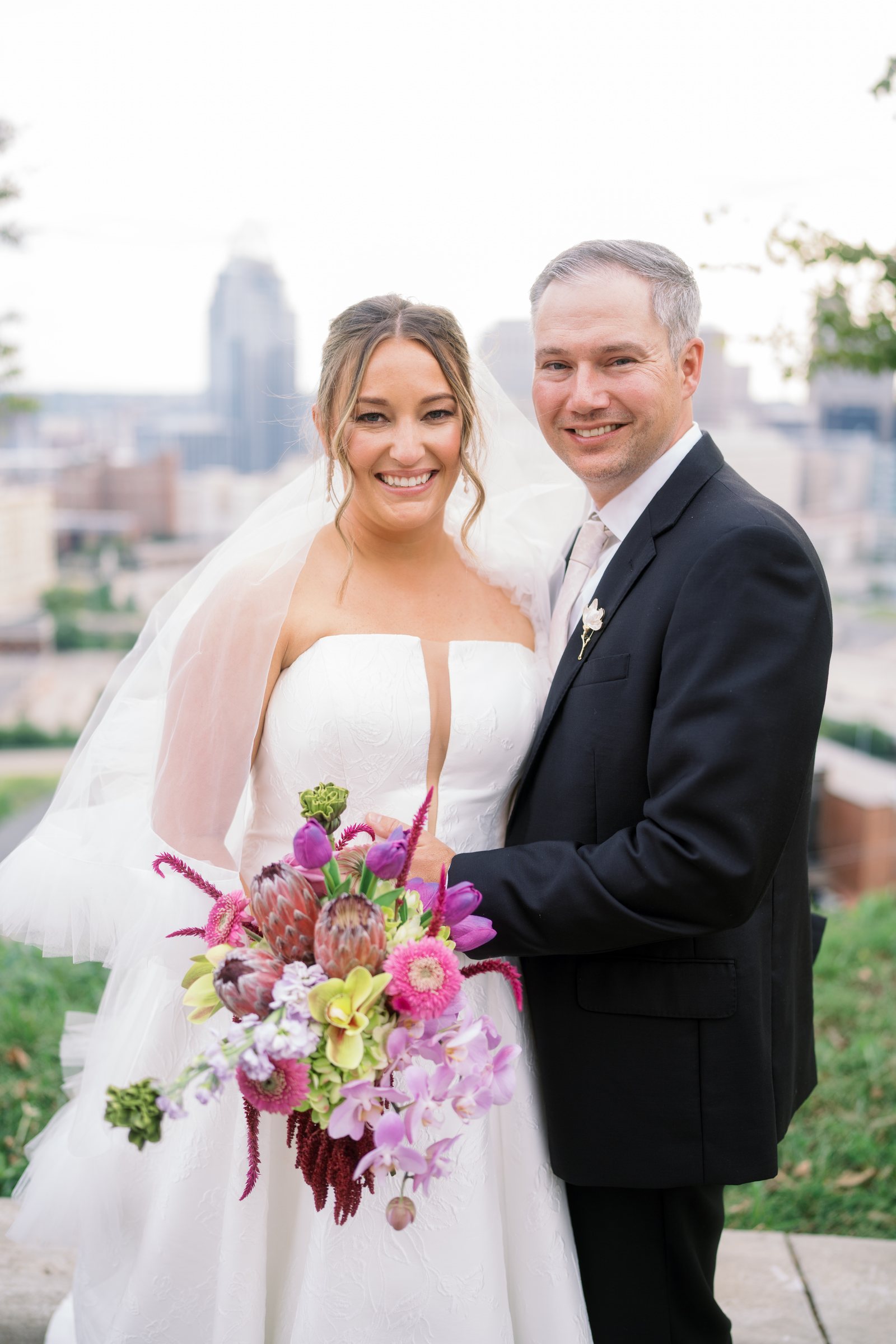Kent and Nicolette posing with the Cincinnati skyline behind them
