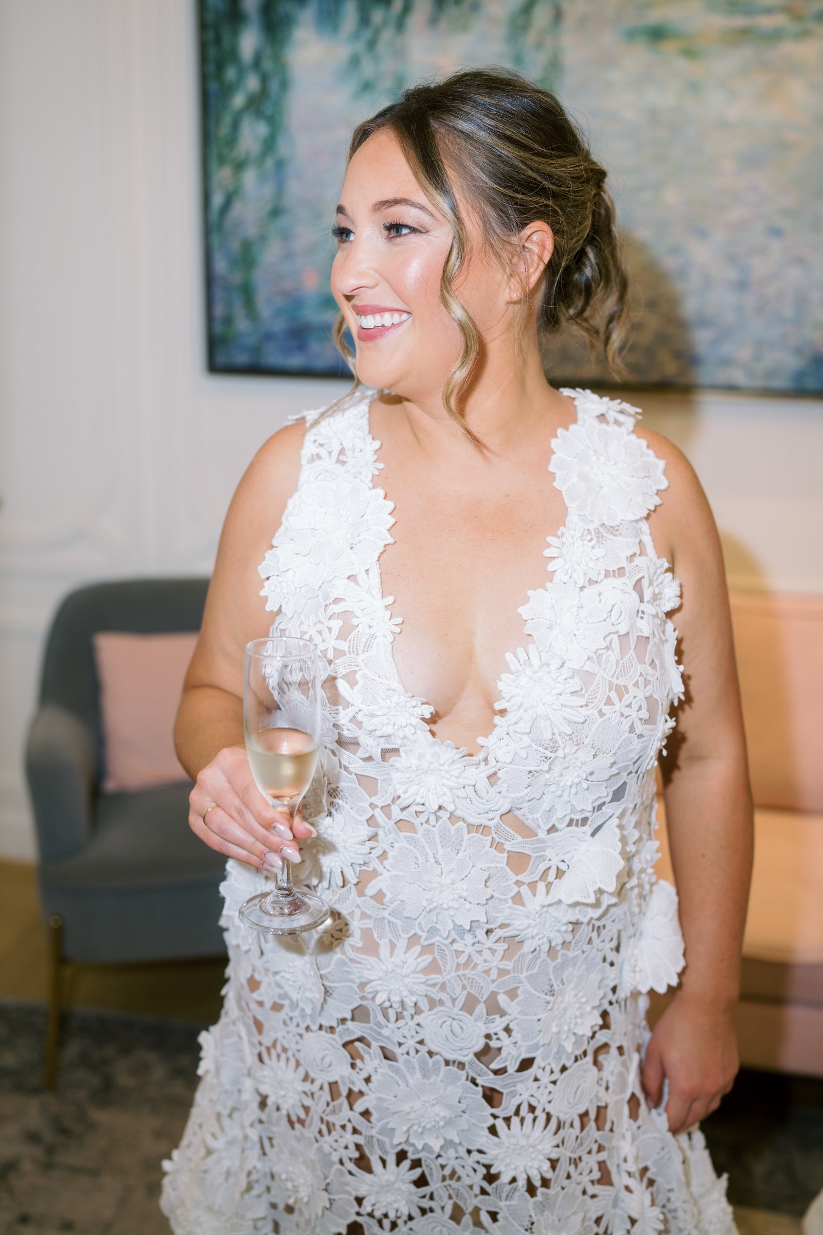 Nicolette smiling in a lace robe while getting ready for her wedding