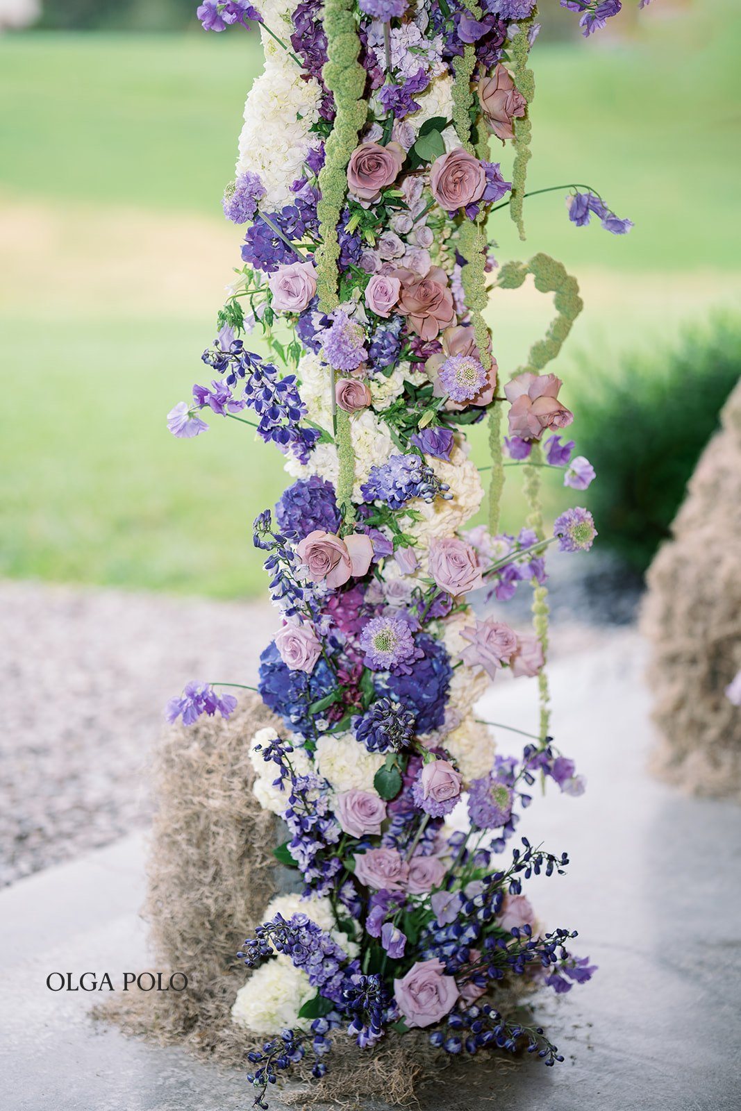 Purple, green and white floral installation at Maia and Troy's ceremony