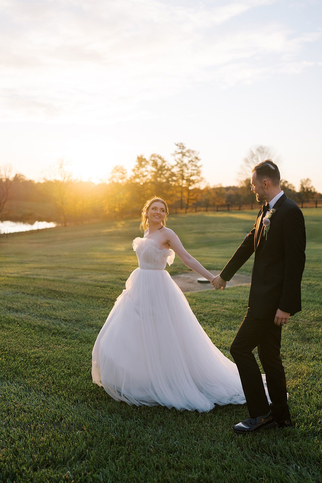 Maia and Troy walking together during sunset portraits at Boone Valley Farm