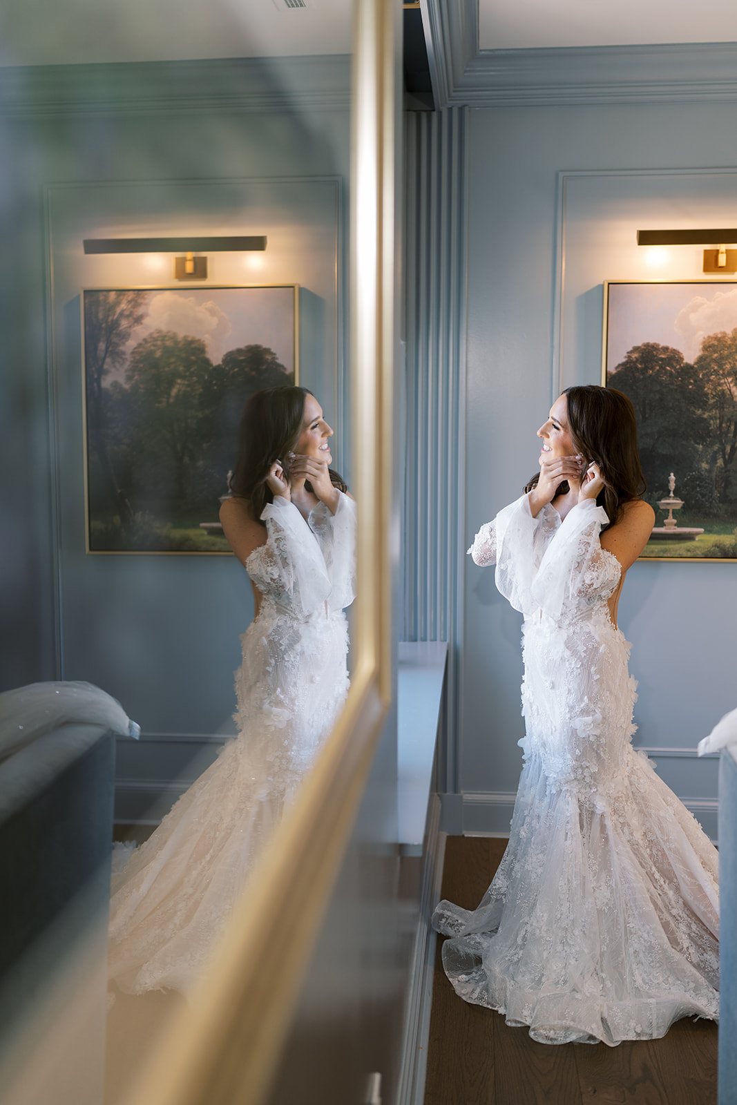 Ronnie getting ready beside a mirror before her wedding at The Palomar Cincinnati