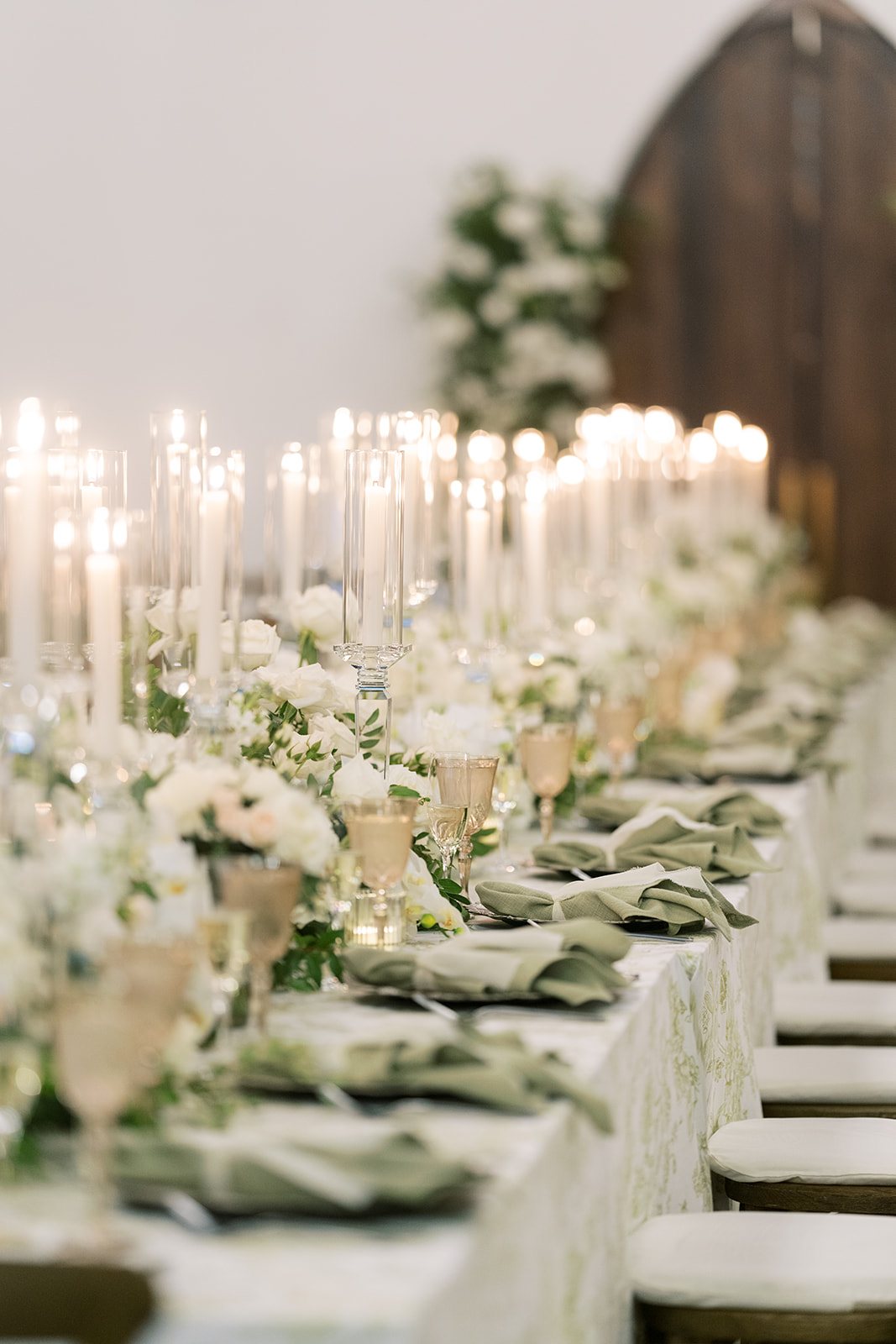 Reception table with white florals and candlelight at Ronnie and Patrick's Palomar wedding