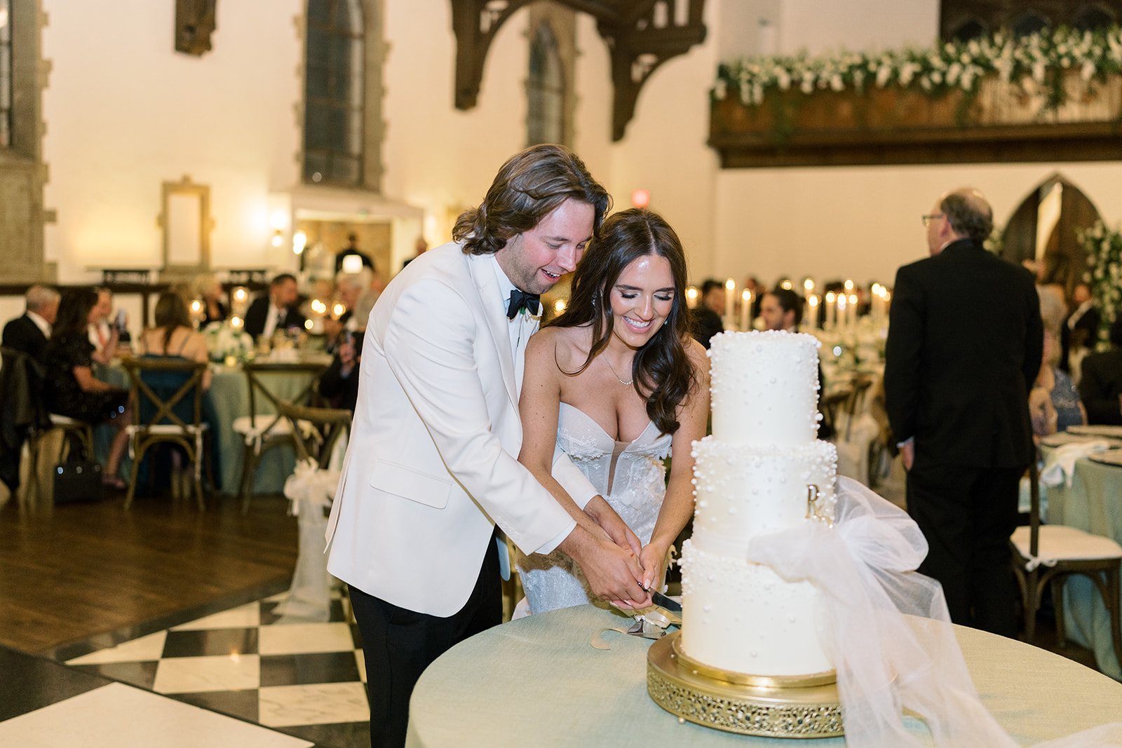 Ronnie and Patrick cutting their wedding cake during the reception