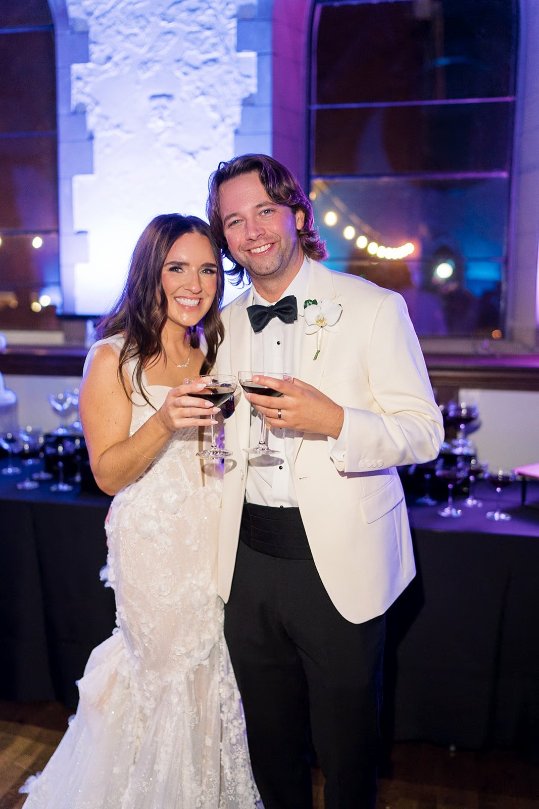 Ronnie and Patrick holding drinks together during the reception at The Palomar Cincinnati