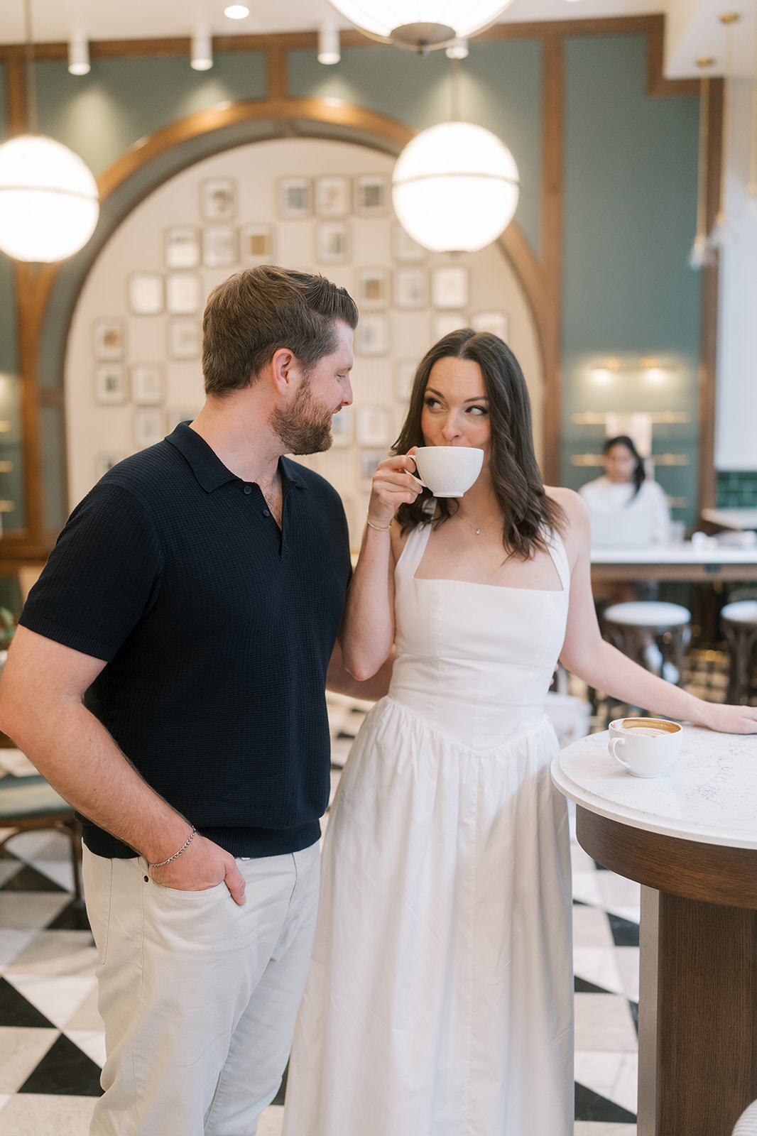Frank and Noelle standing together inside the café