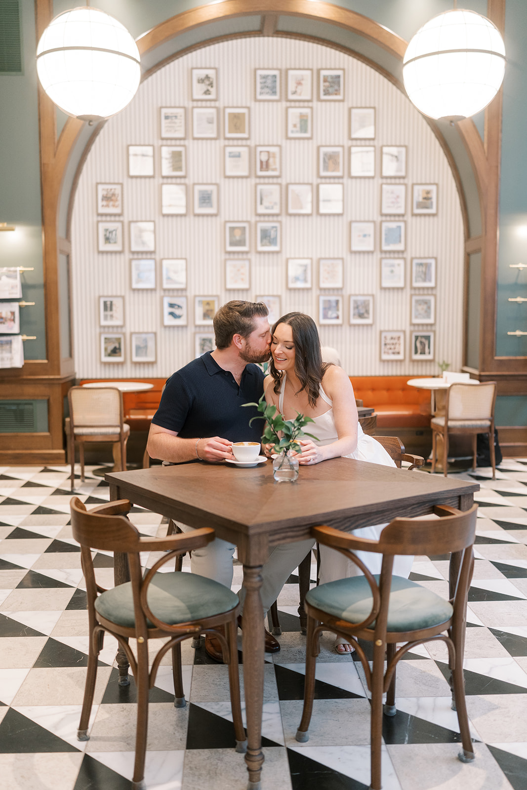 Wide portrait of Frank and Noelle seated together inside the café