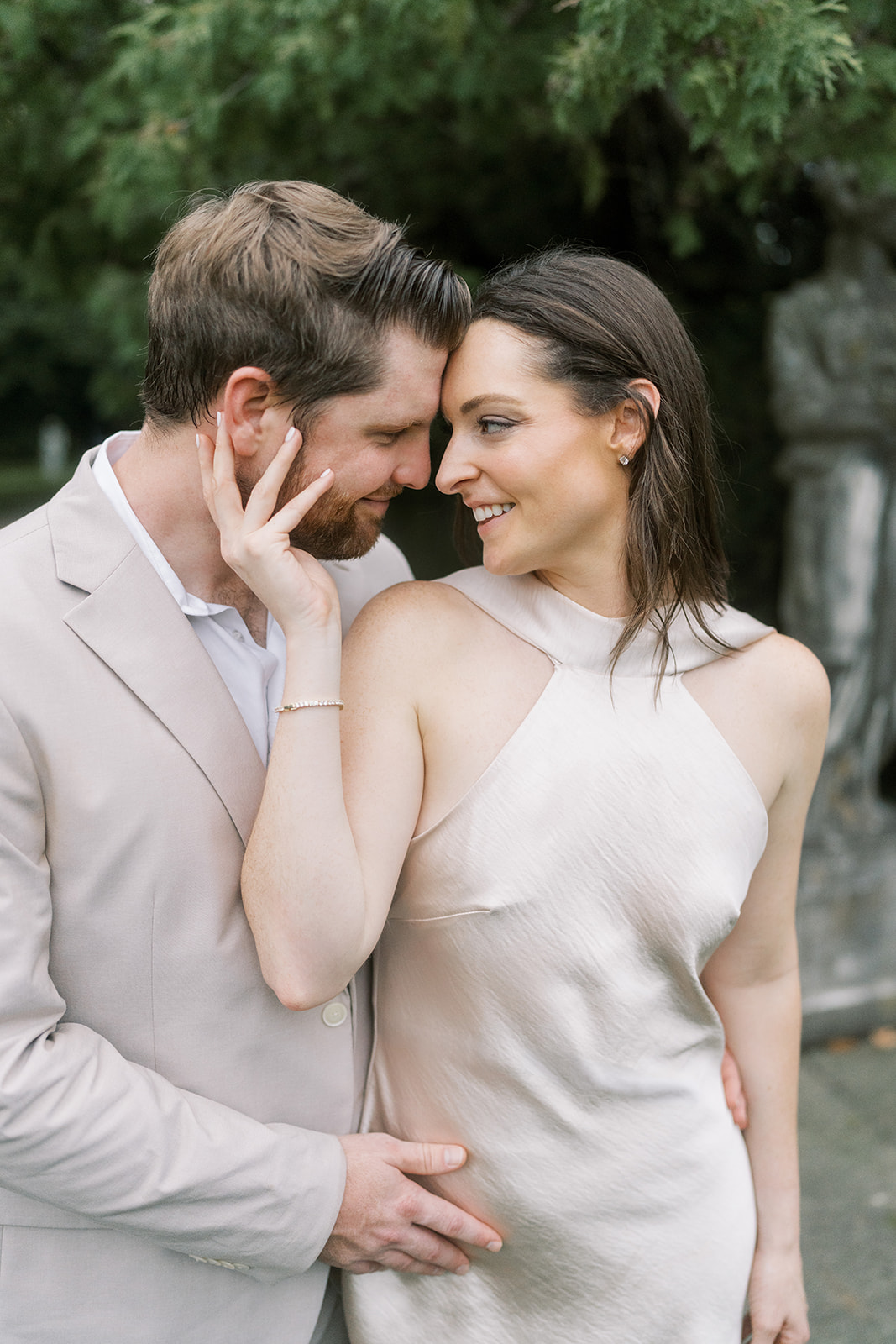 Close portrait of Frank and Noelle smiling together in the Laurel Court garden