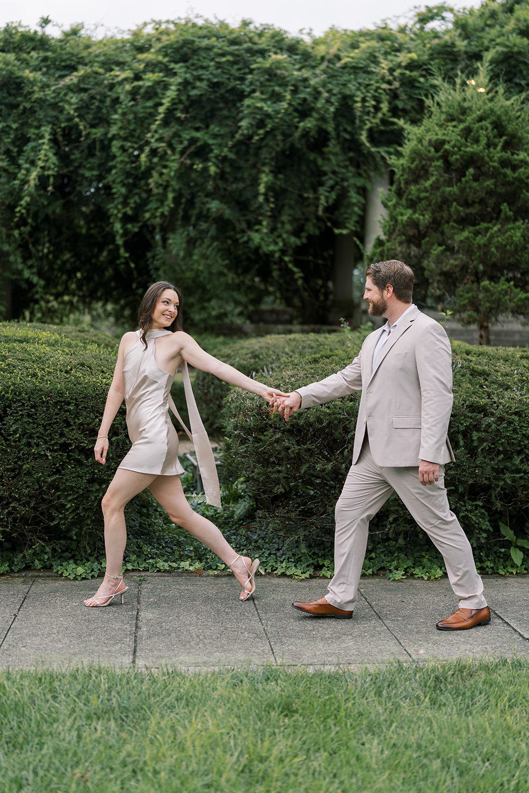 Frank and Noelle walking together along a garden path at Laurel Court