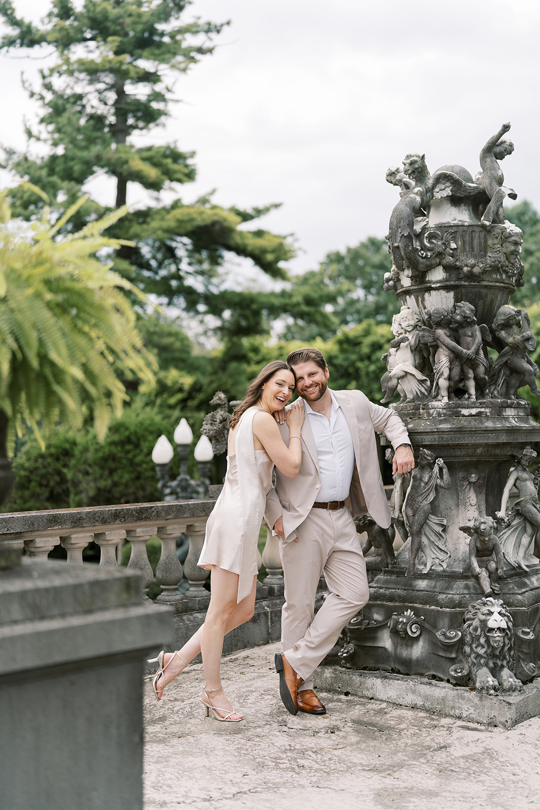 Frank and Noelle leaning together beside an ornate stone balustrade at Laurel Court