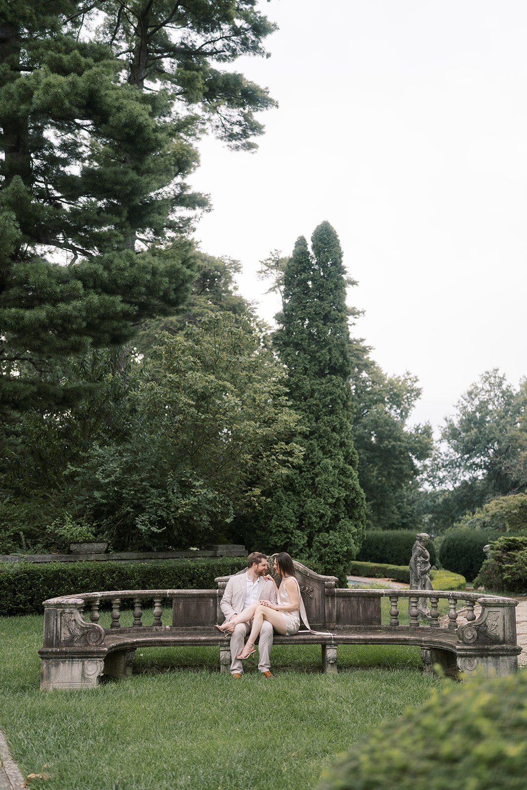 Wide garden portrait of Frank and Noelle seated together at Laurel Court