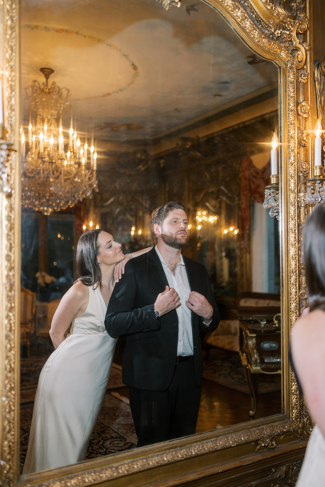 Frank and Noelle reflected together in a gilded mirror at Laurel Court