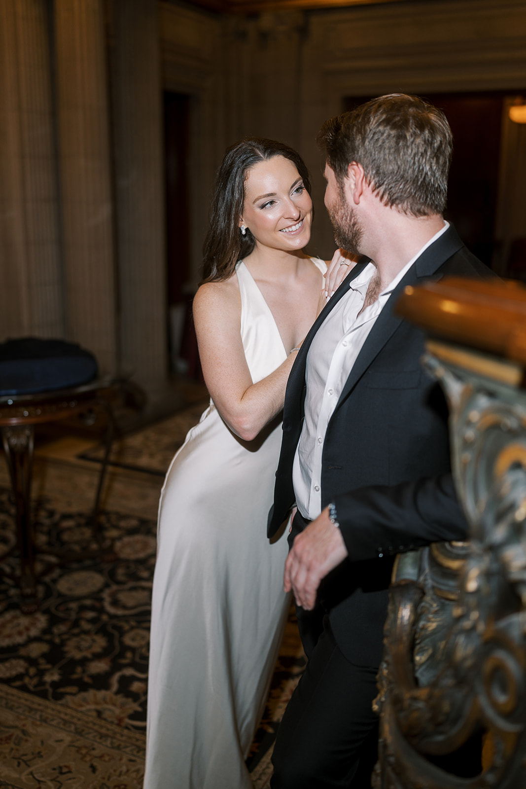 Frank and Noelle together beside the ornate interior staircase at Laurel Court