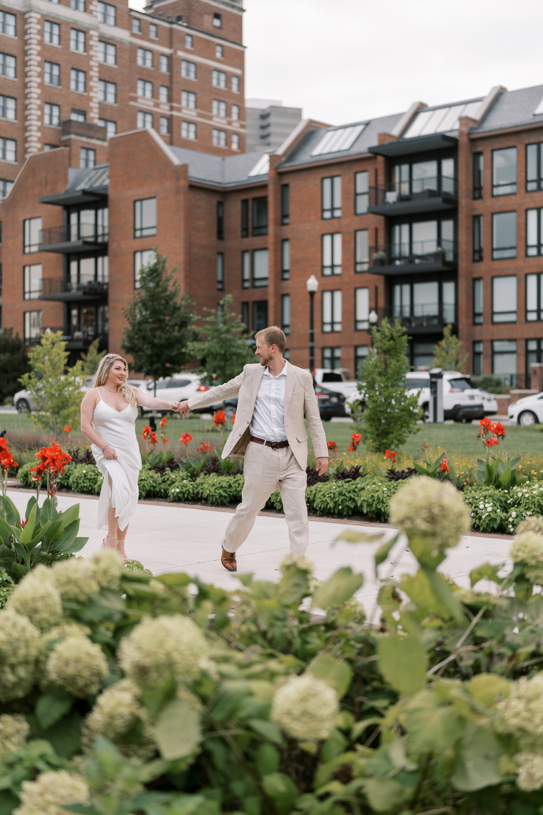 Josh and Autumn walking together outside The Lytle Park Hotel