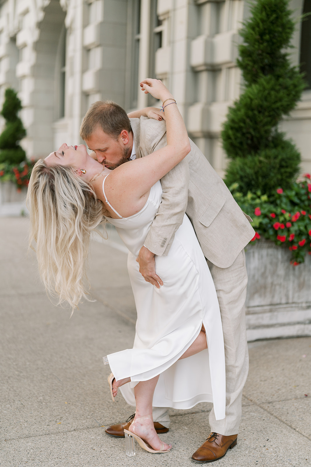 Josh dipping Autumn for a kiss outside The Lytle Park Hotel