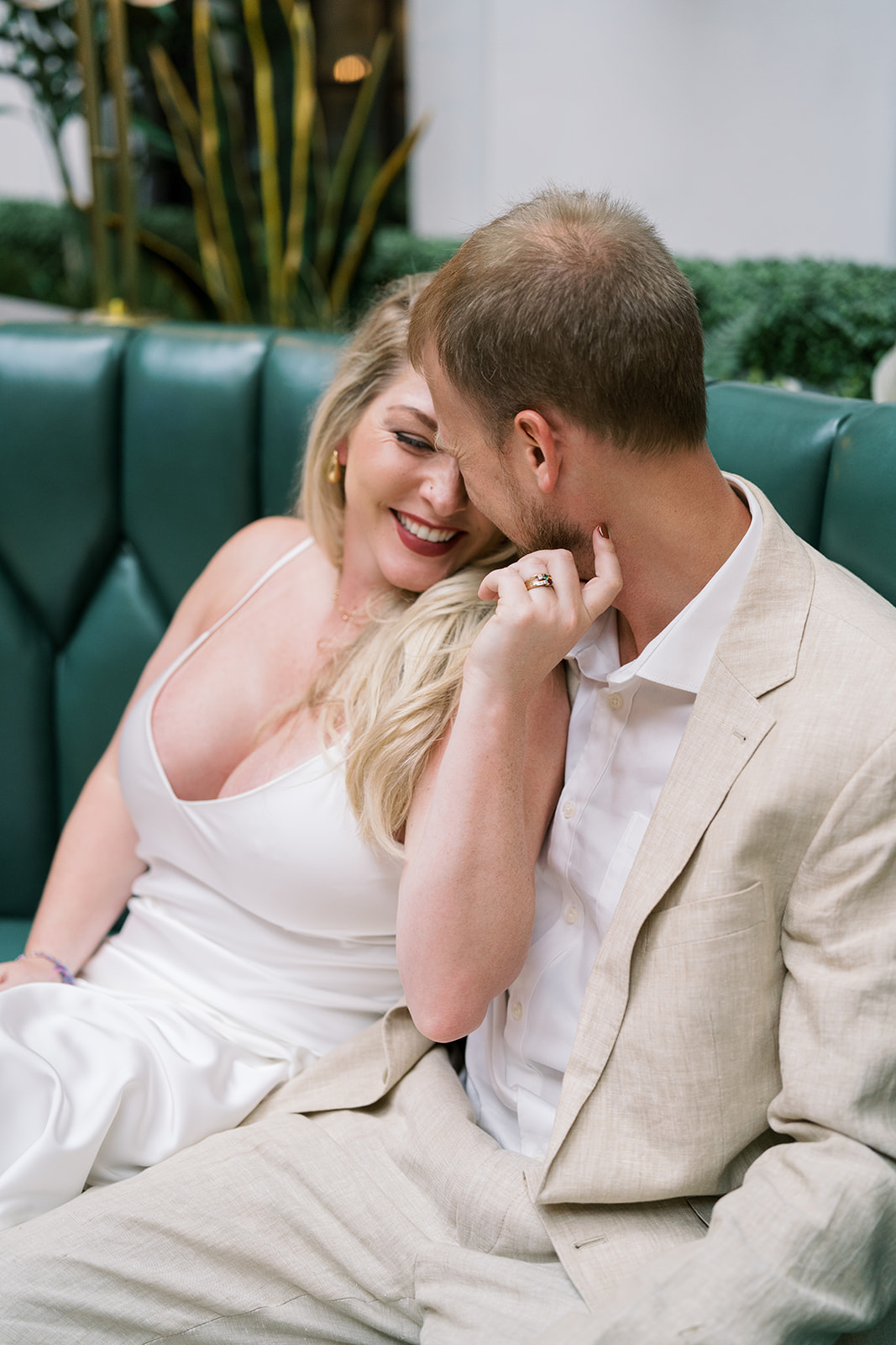 Close portrait of Josh and Autumn together on green lounge seating