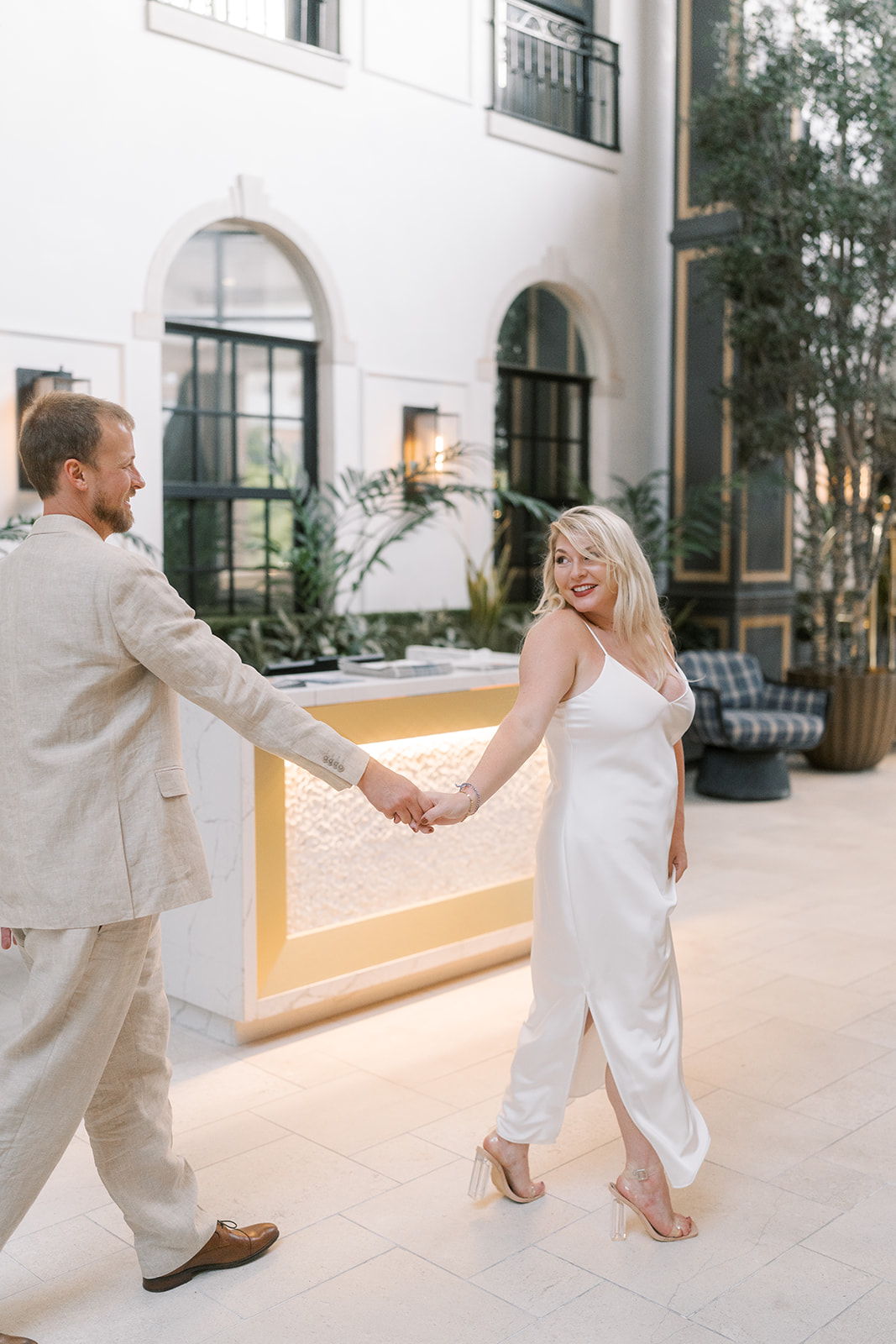 Josh and Autumn walking together through the hotel lobby