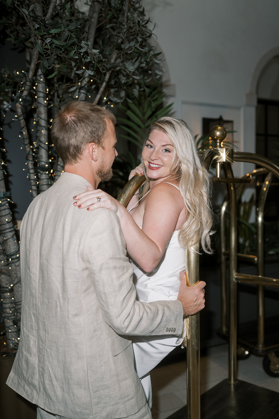 Close portrait of Josh and Autumn kissing beside the luggage cart
