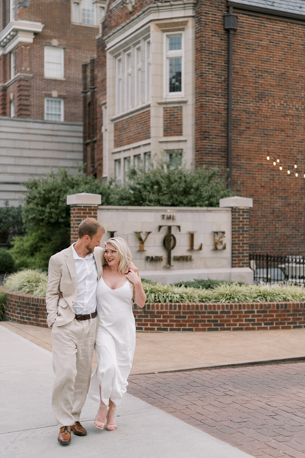 Josh and Autumn together beside The Lytle Park Hotel exterior