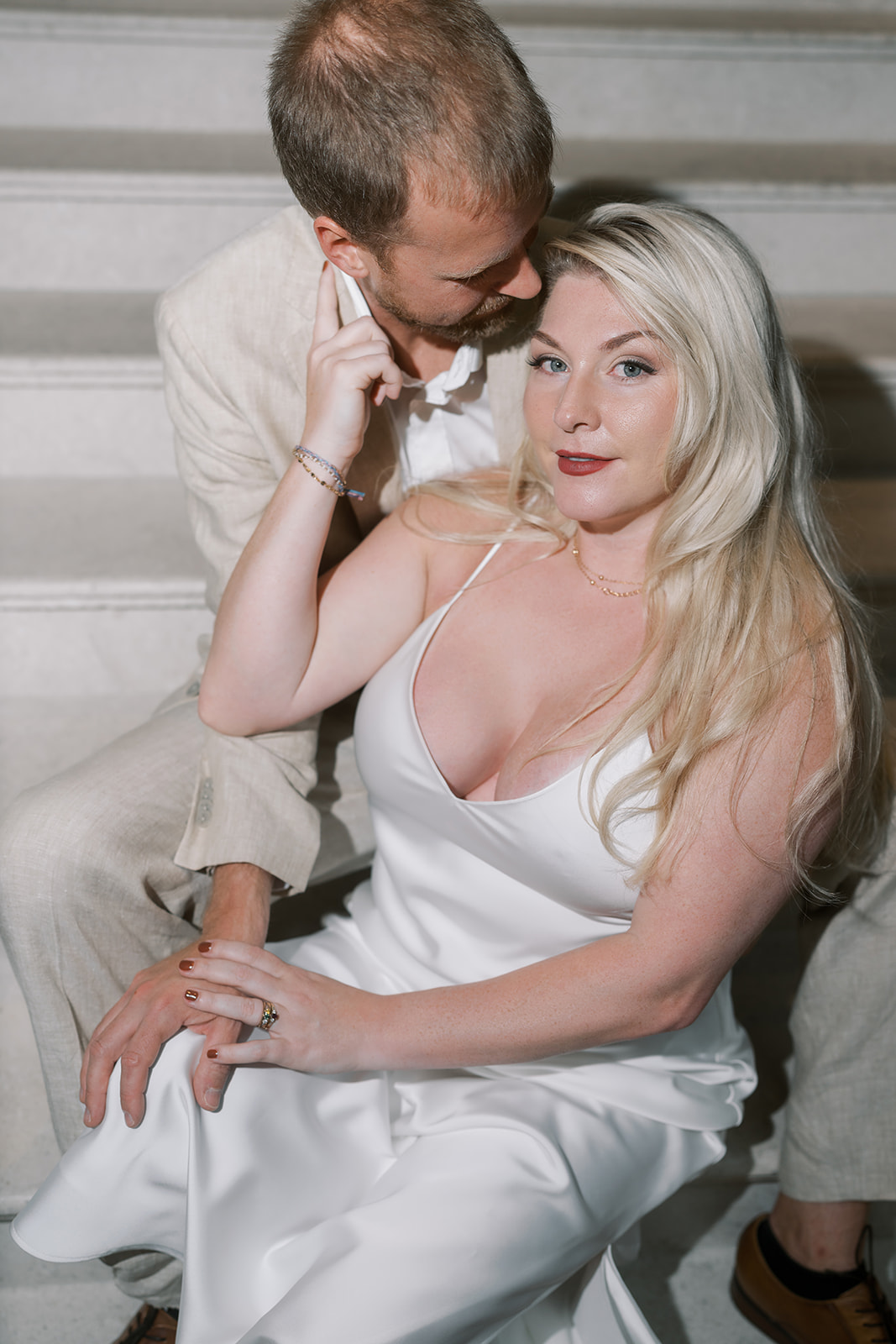 Josh and Autumn seated together on the hotel staircase
