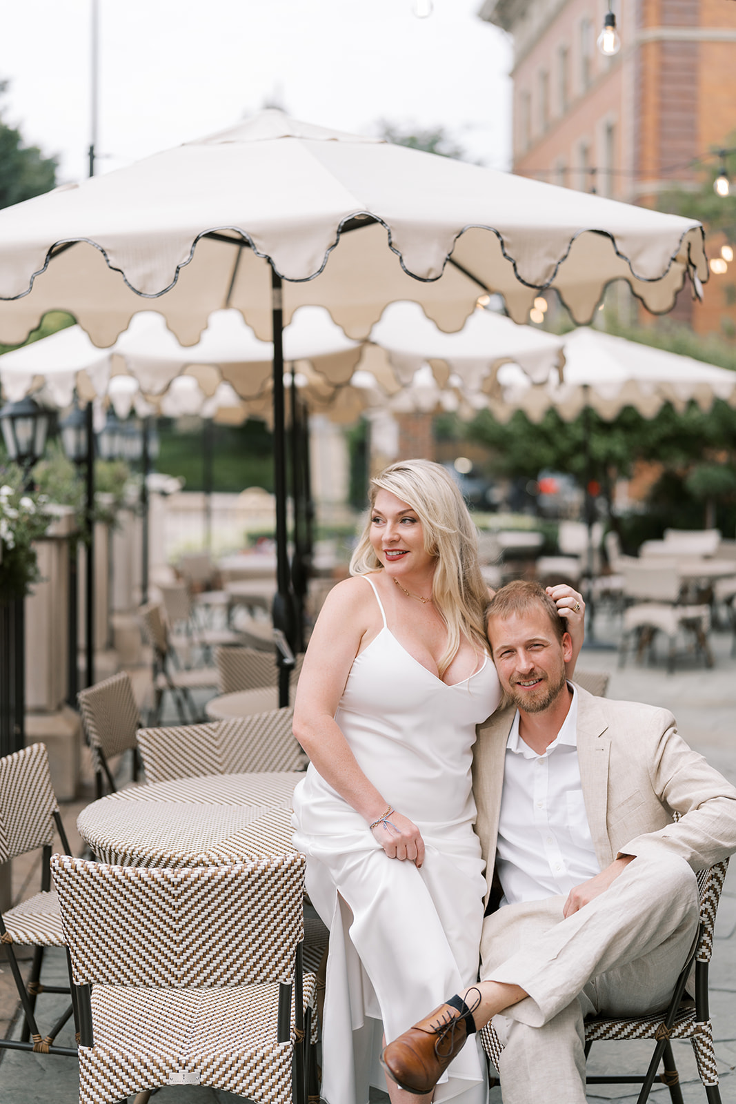 Vertical portrait of Josh and Autumn seated on the terrace