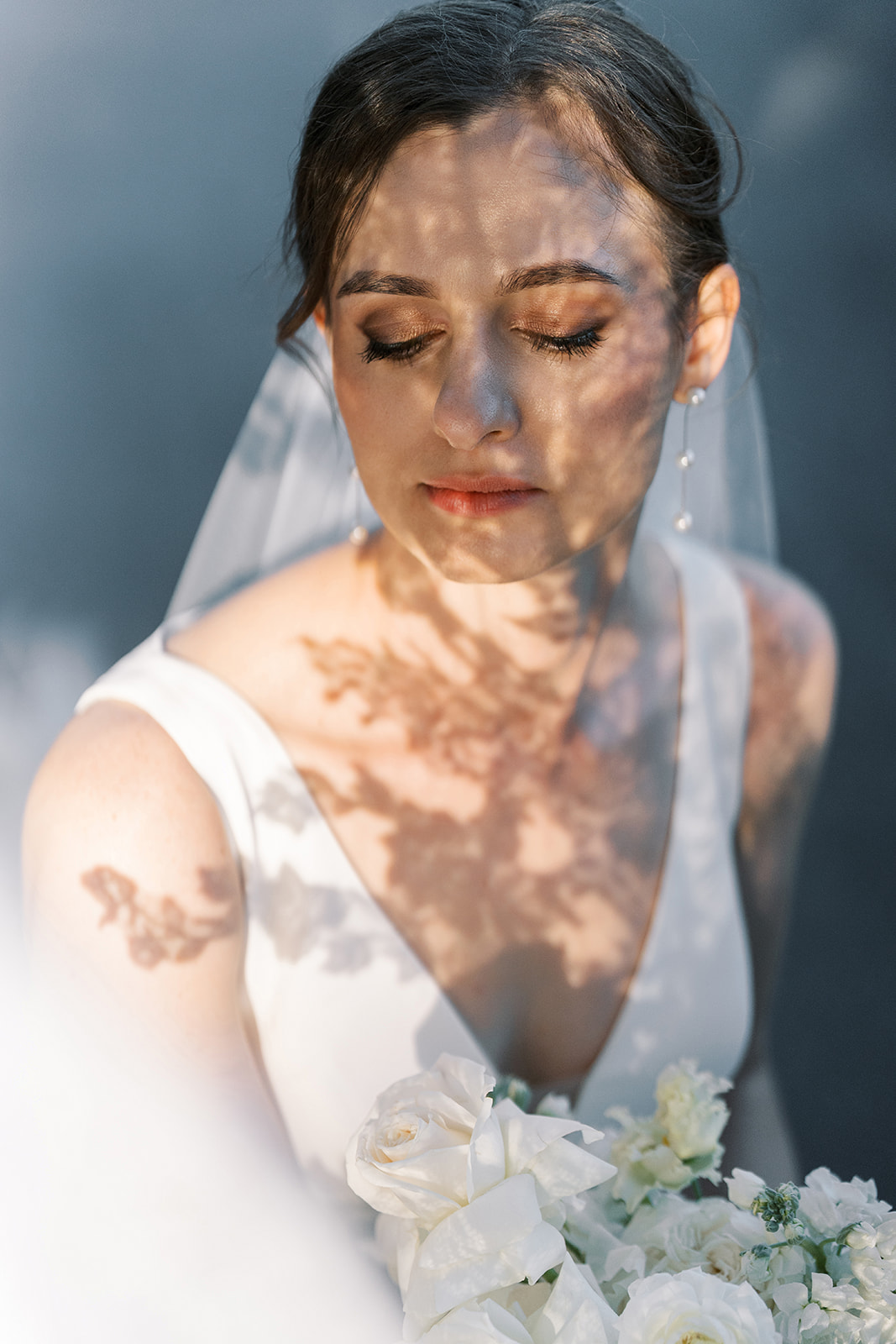 Julia in a bridal portrait with leaf shadows across her face