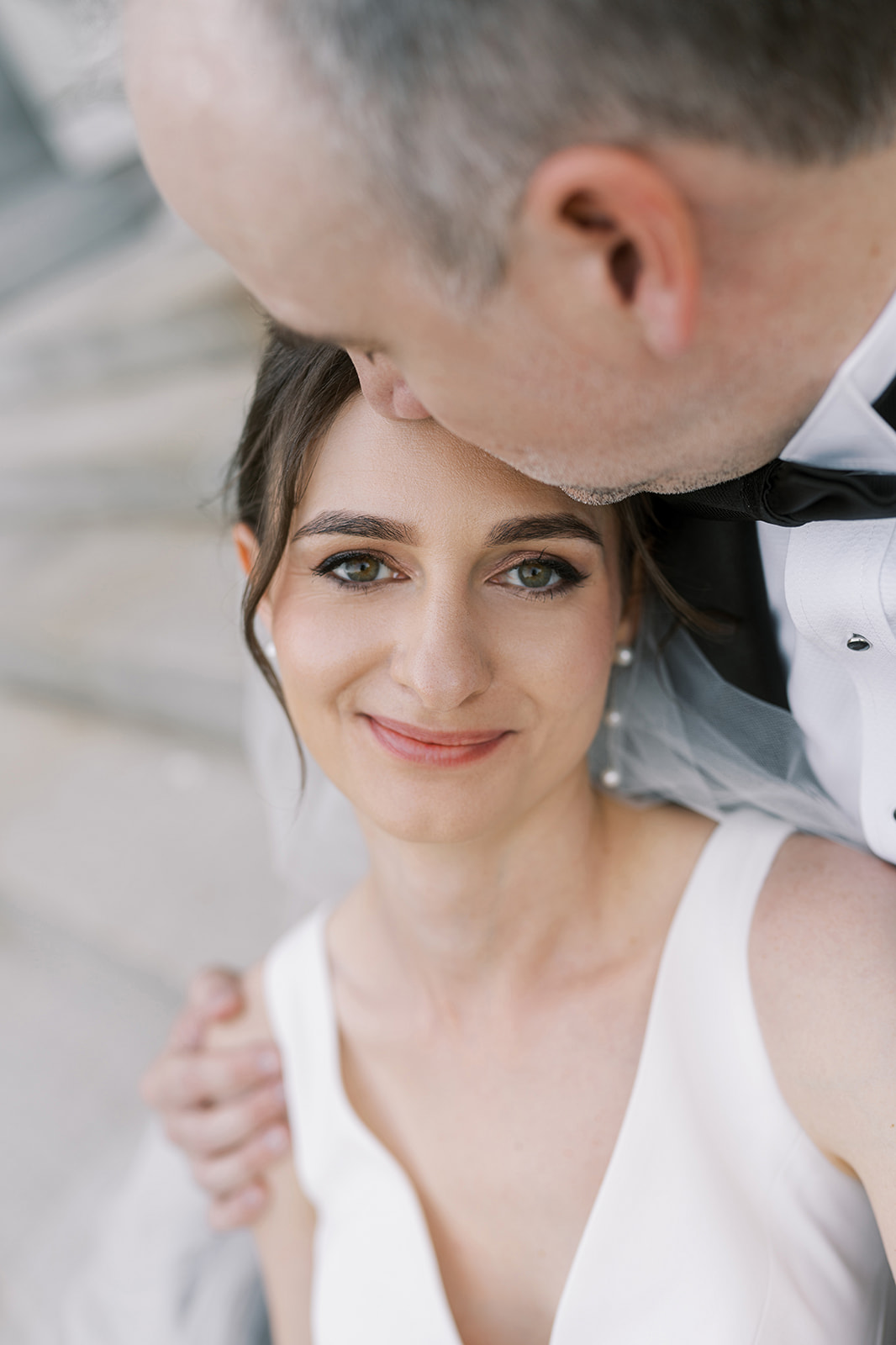 Close bridal portrait of Julia with Michael beside her
